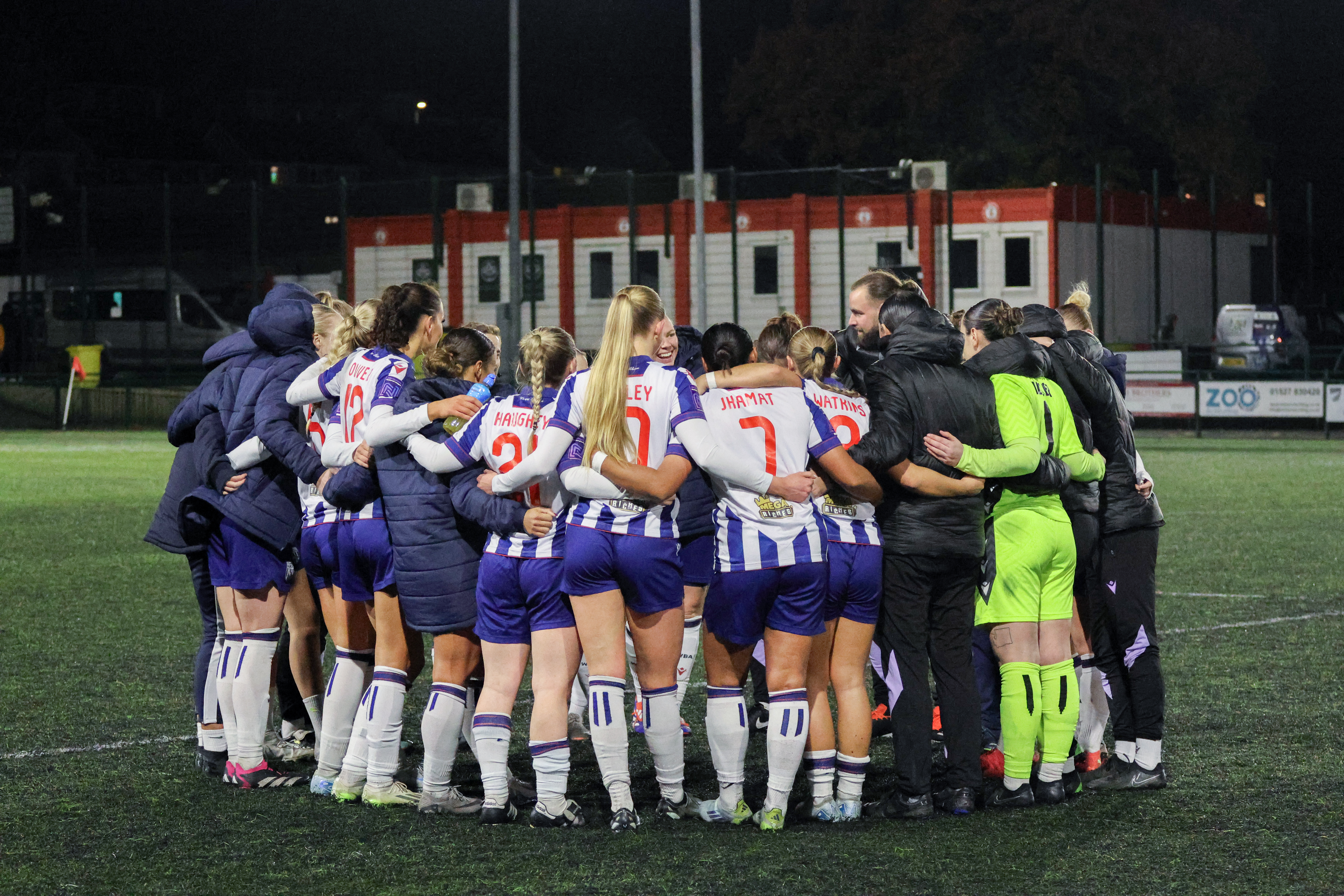 A general view of Albion Women players and staff in a huddle after a game in the home kit 