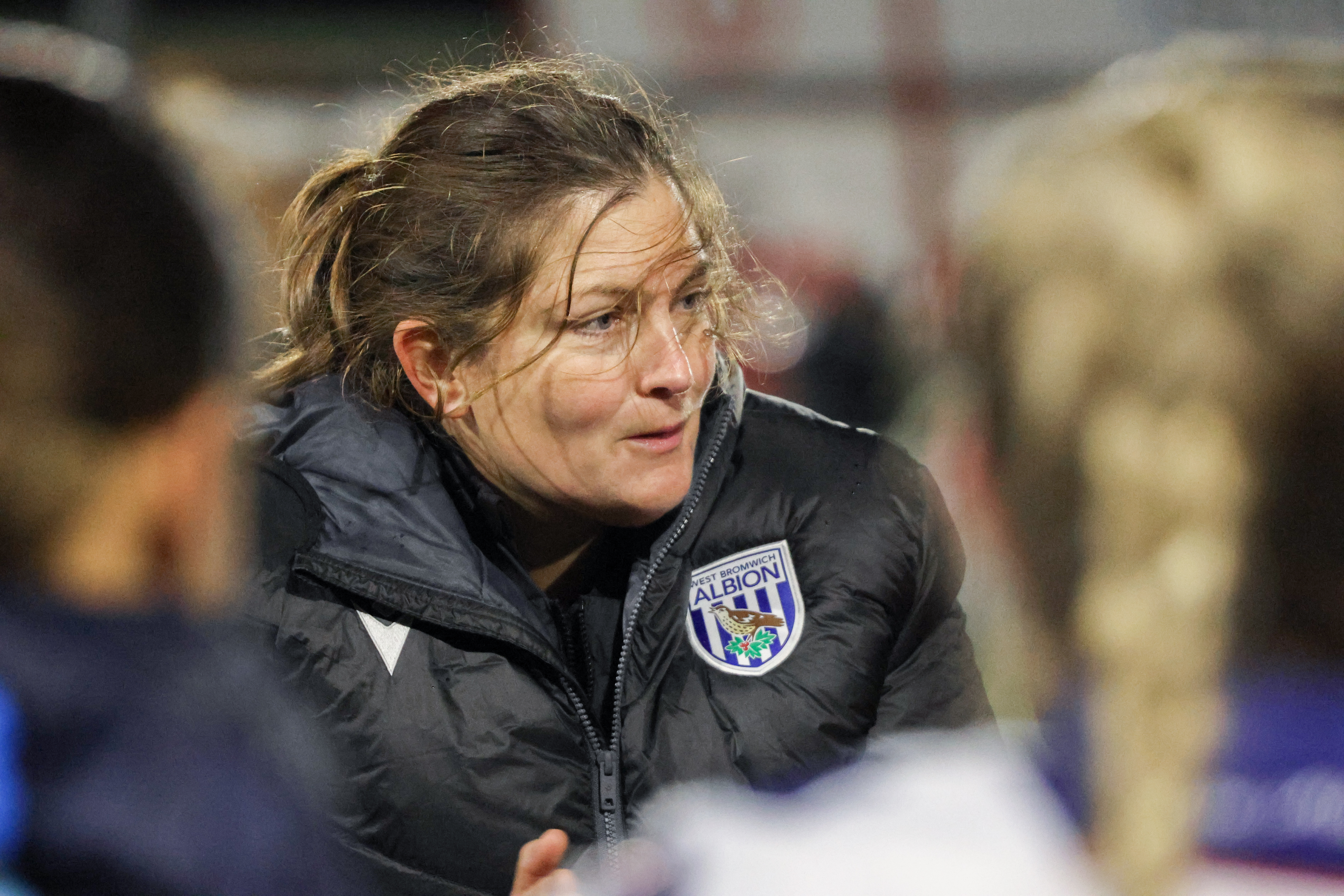 Siobhan Hodgetts-Still on the side of the pitch in a coat