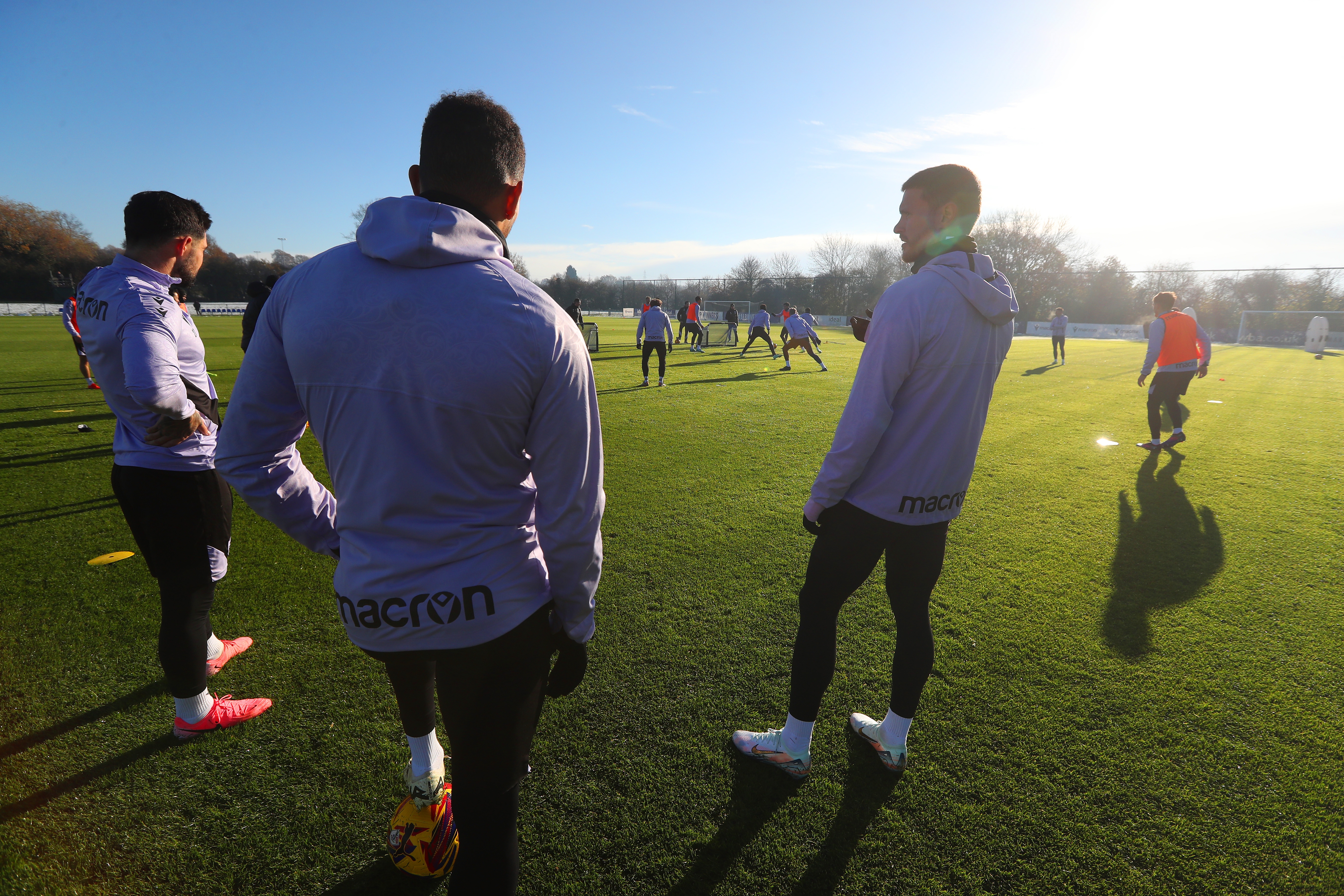 A group of players watching a training session 