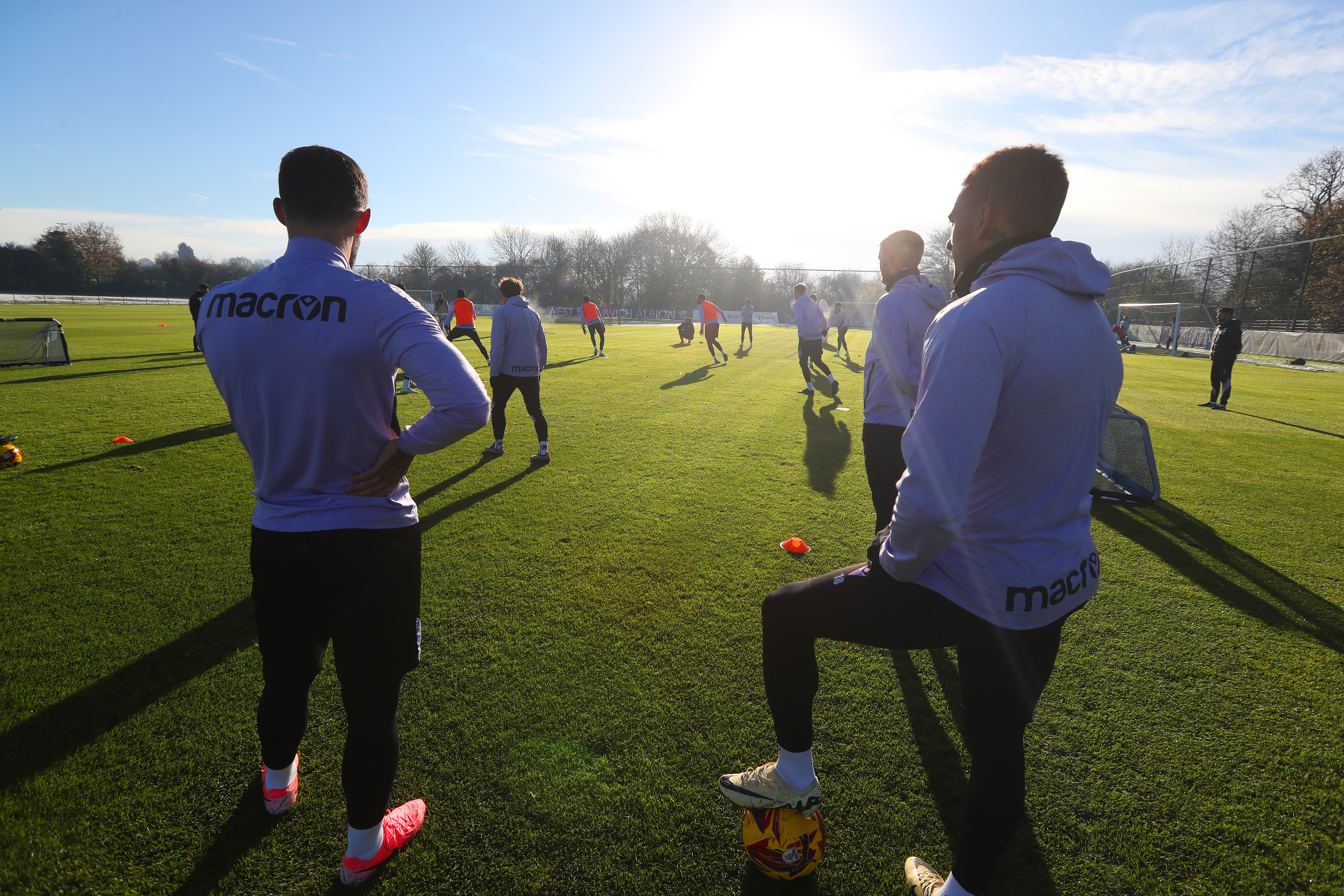 A group of players watching a training session 