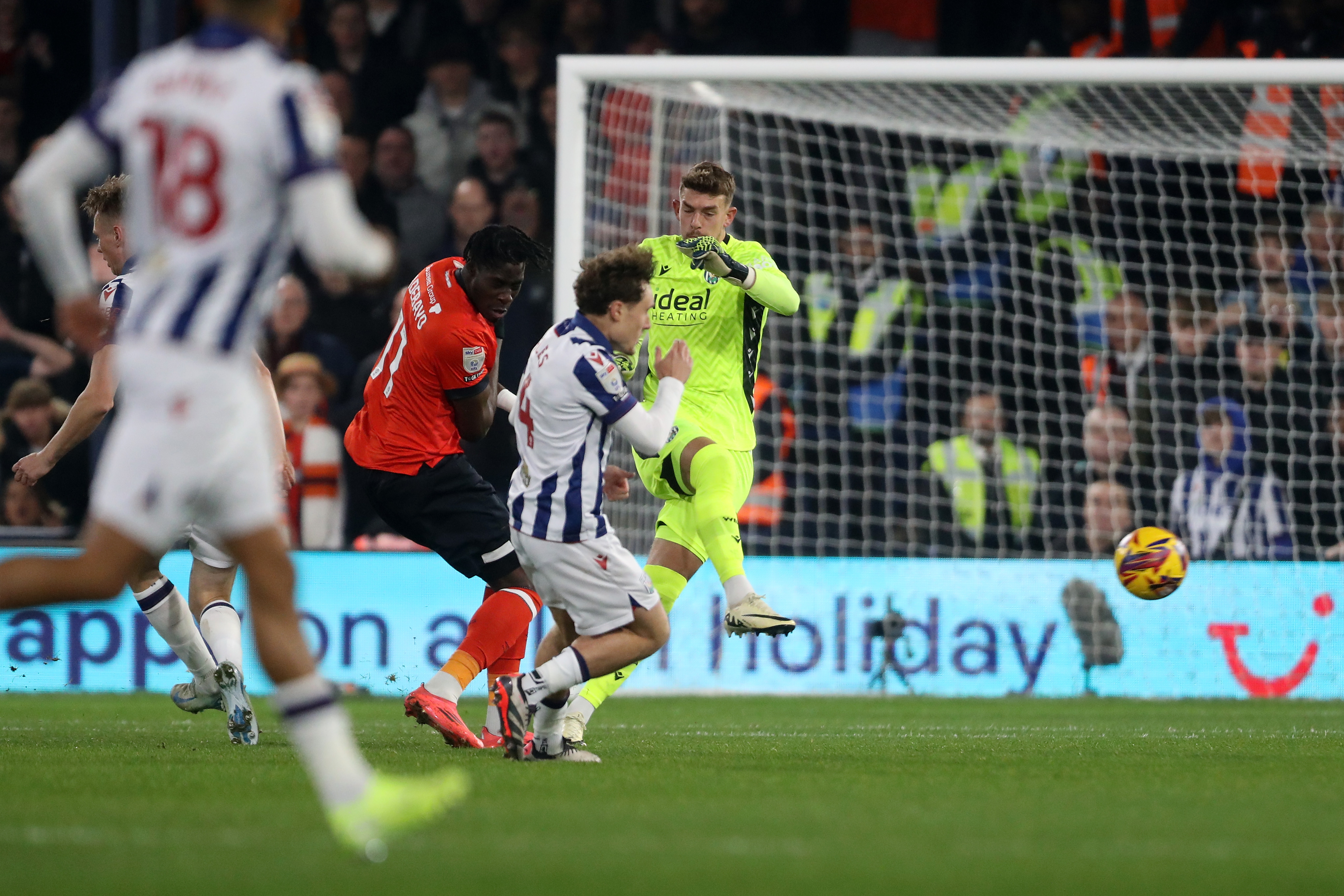 Alex Palmer clearing the ball under pressure at Luton 