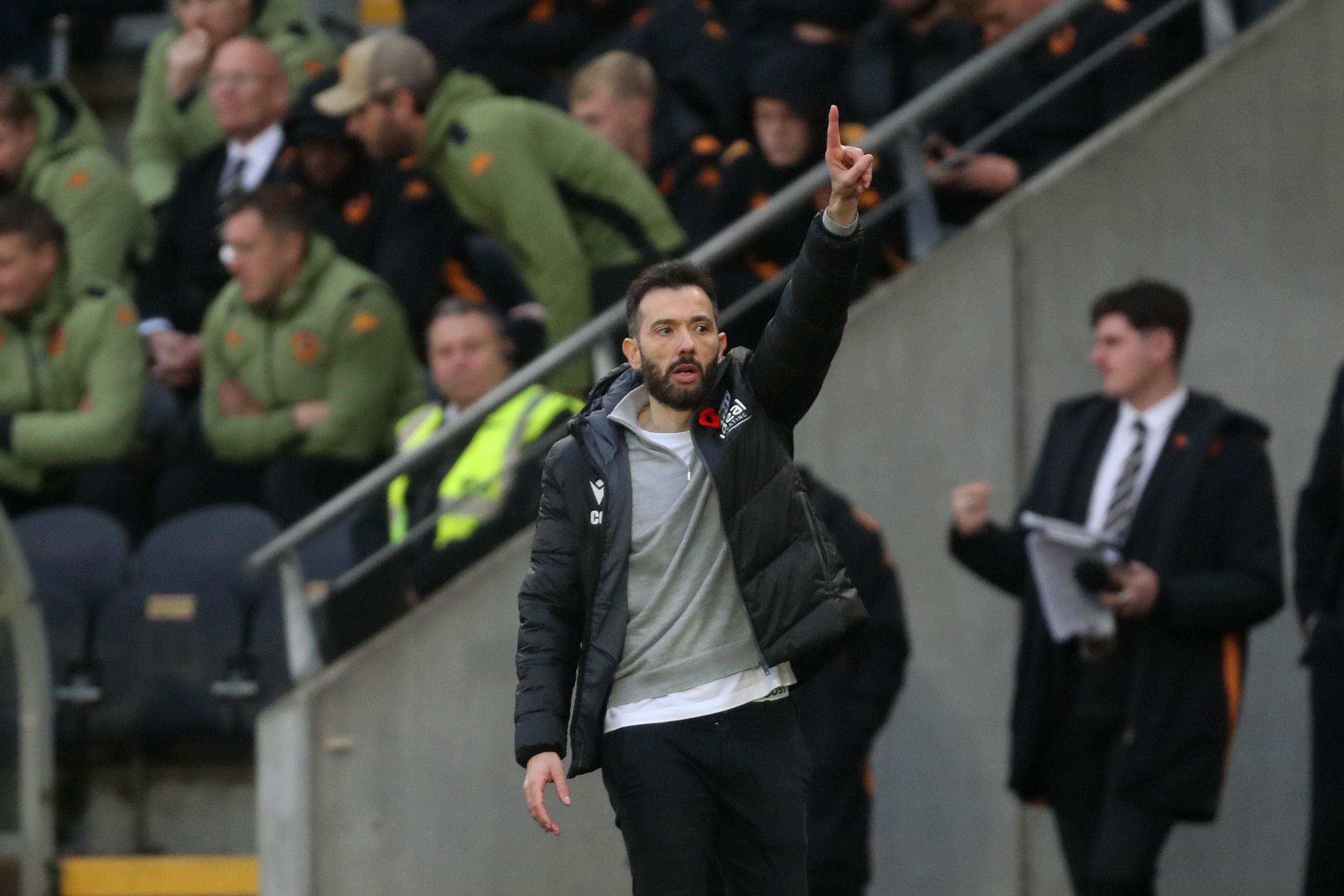 Carlos Corberán on the side of the pitch at Hull pointing up with one finger 