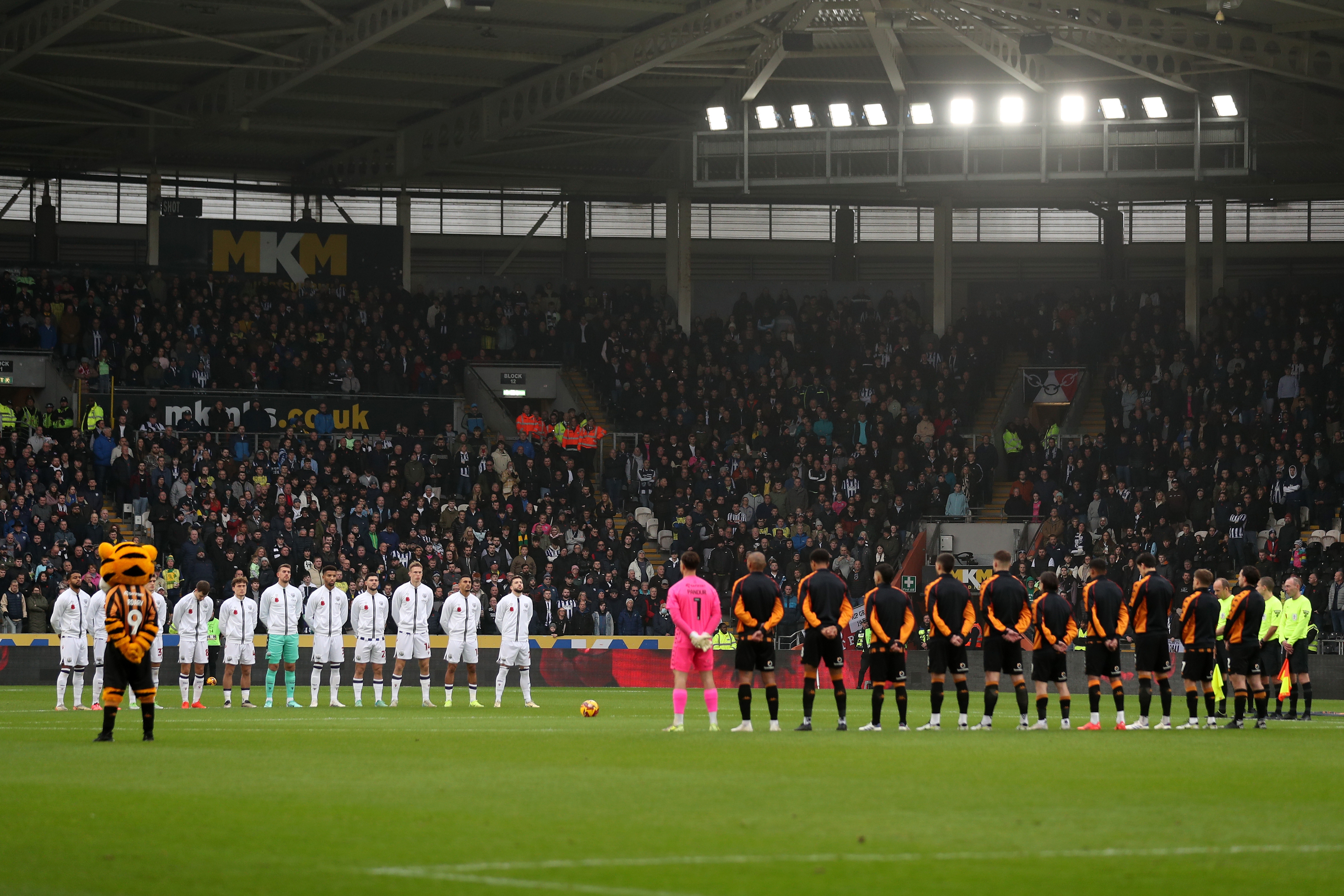 Albion and Hull players stand together during a Remembrance Sunday minute's silence 