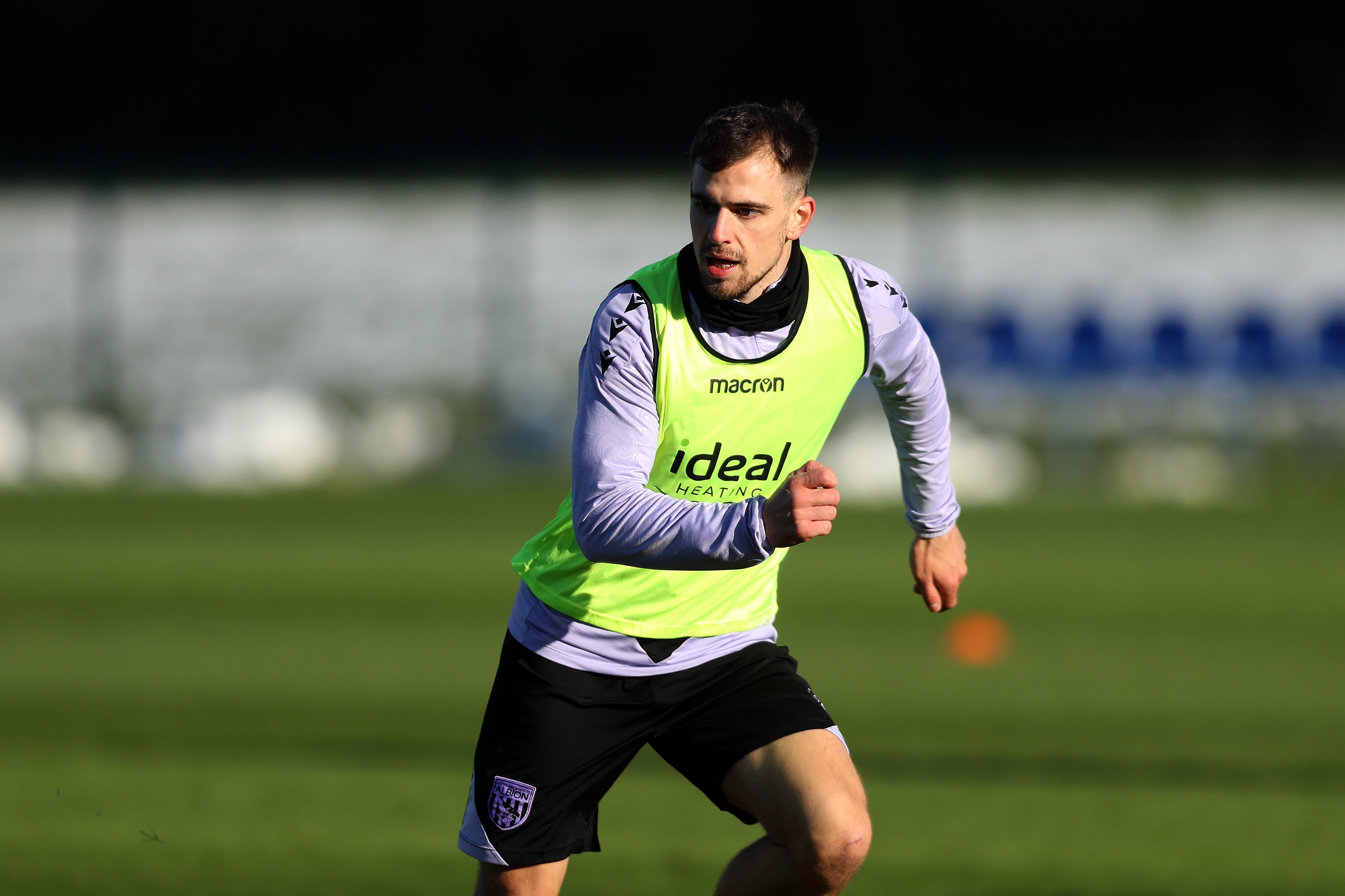 Jayson Molumby running forward during training 