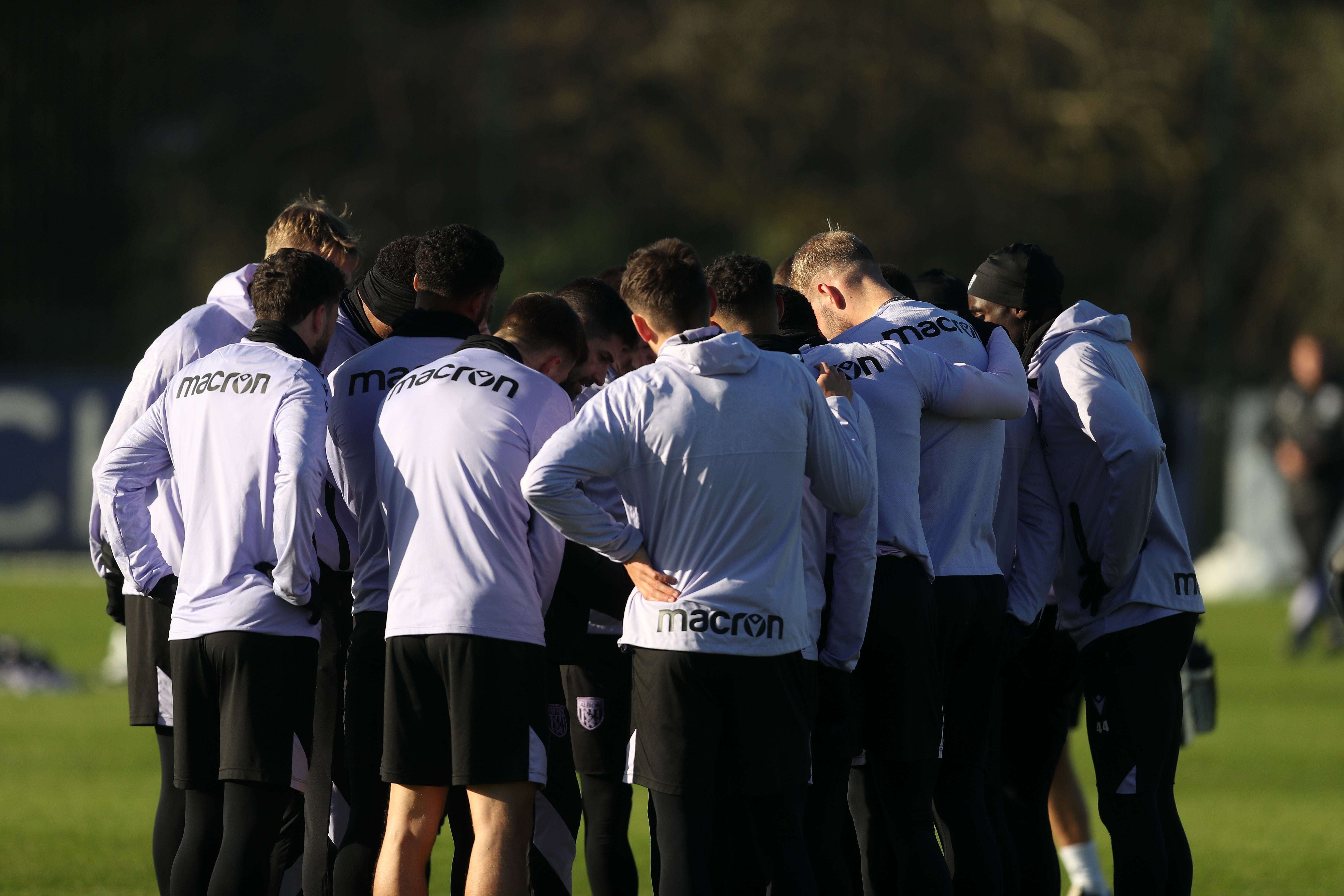 A group of Albion players in a huddle during training 