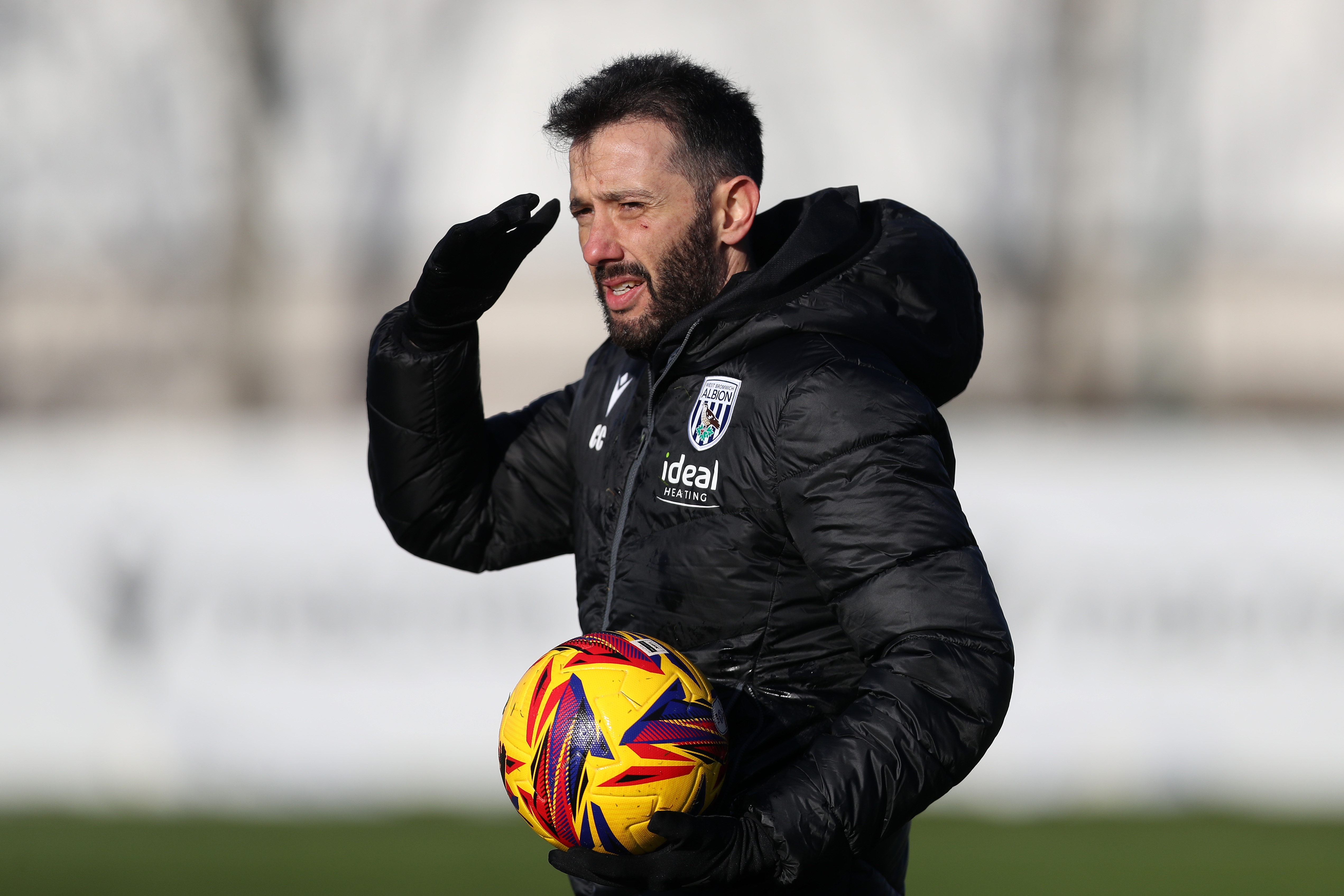 Carlos Corberán holding a ball during a training session 