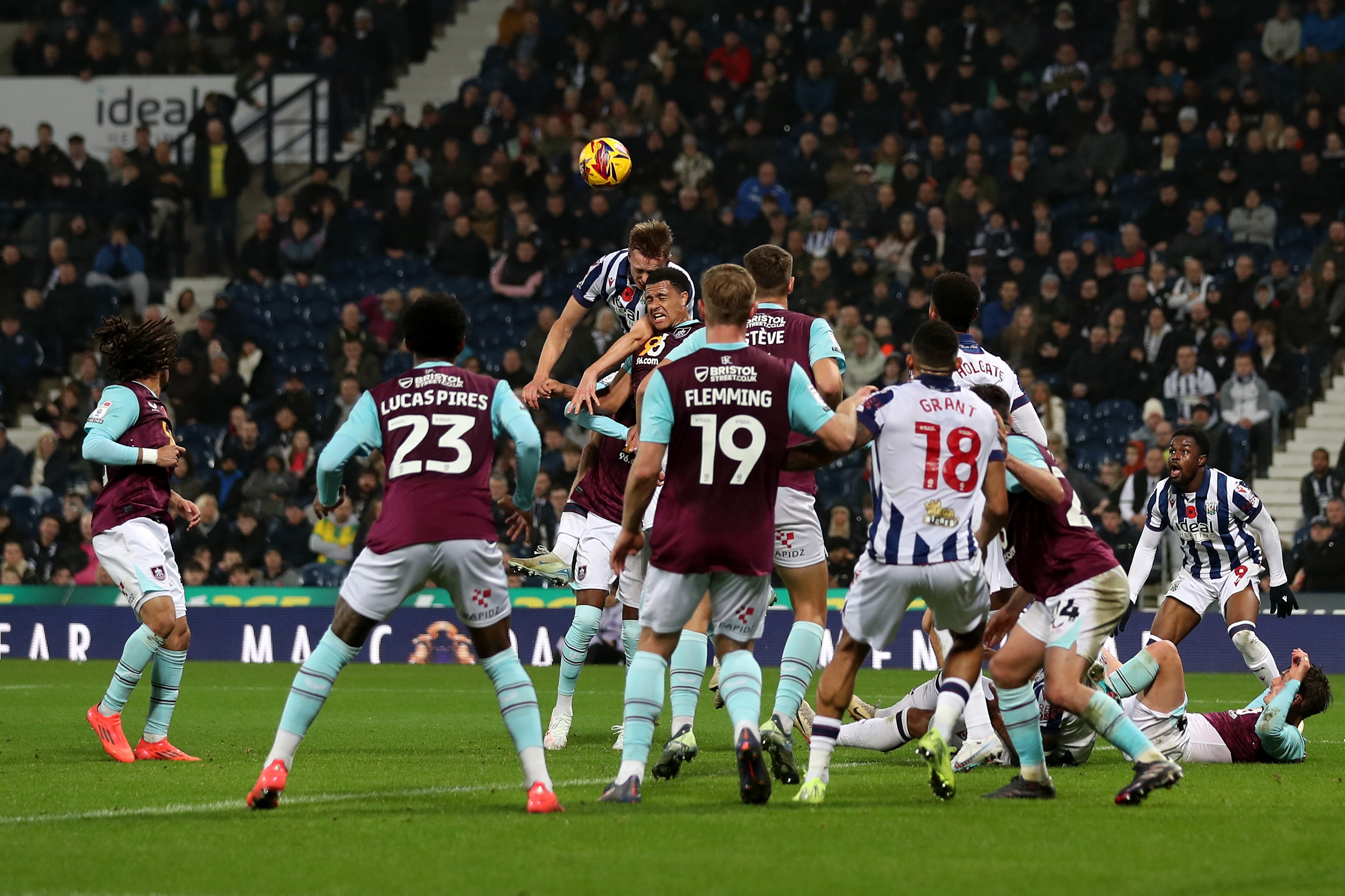 Several Albion and Burnley players battling for the ball in the air 