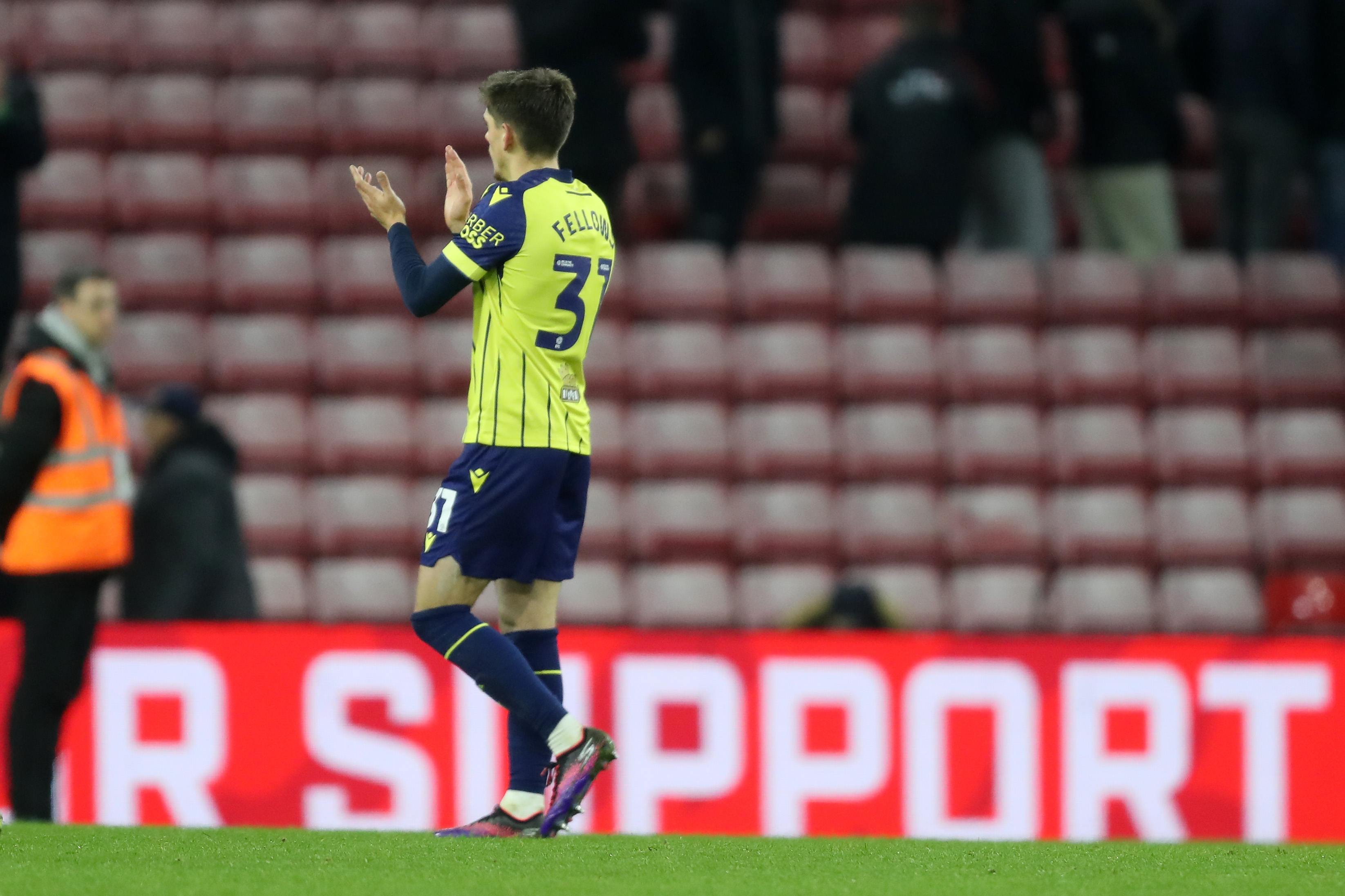 Tom Fellows applauding Albion fans at Sunderland wearing the yellow and blue away kit 