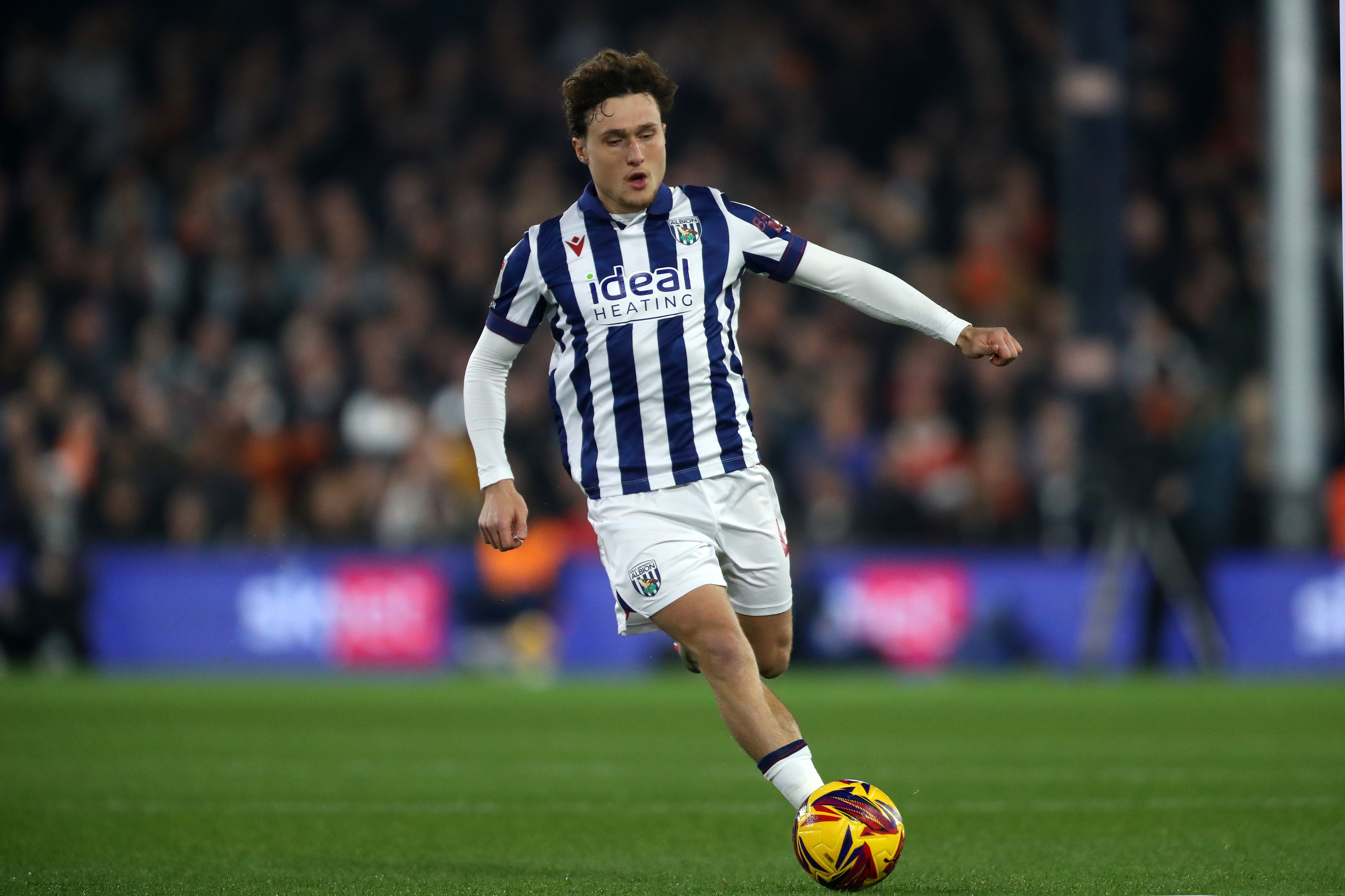 Callum Styles on the ball at Luton in the home kit 