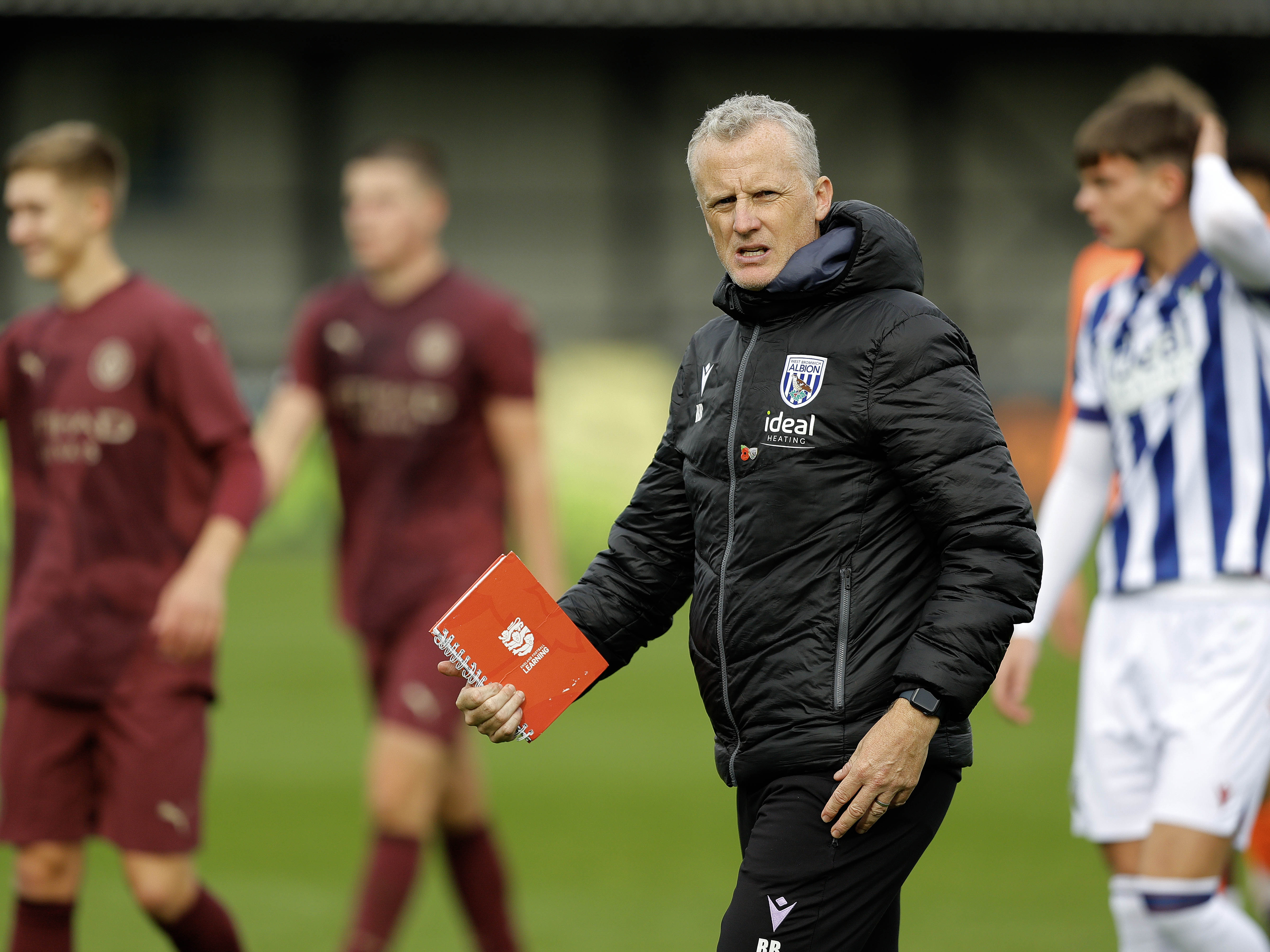 A photo of Albion U21 boss Richard Beale in a black Baggies training coat