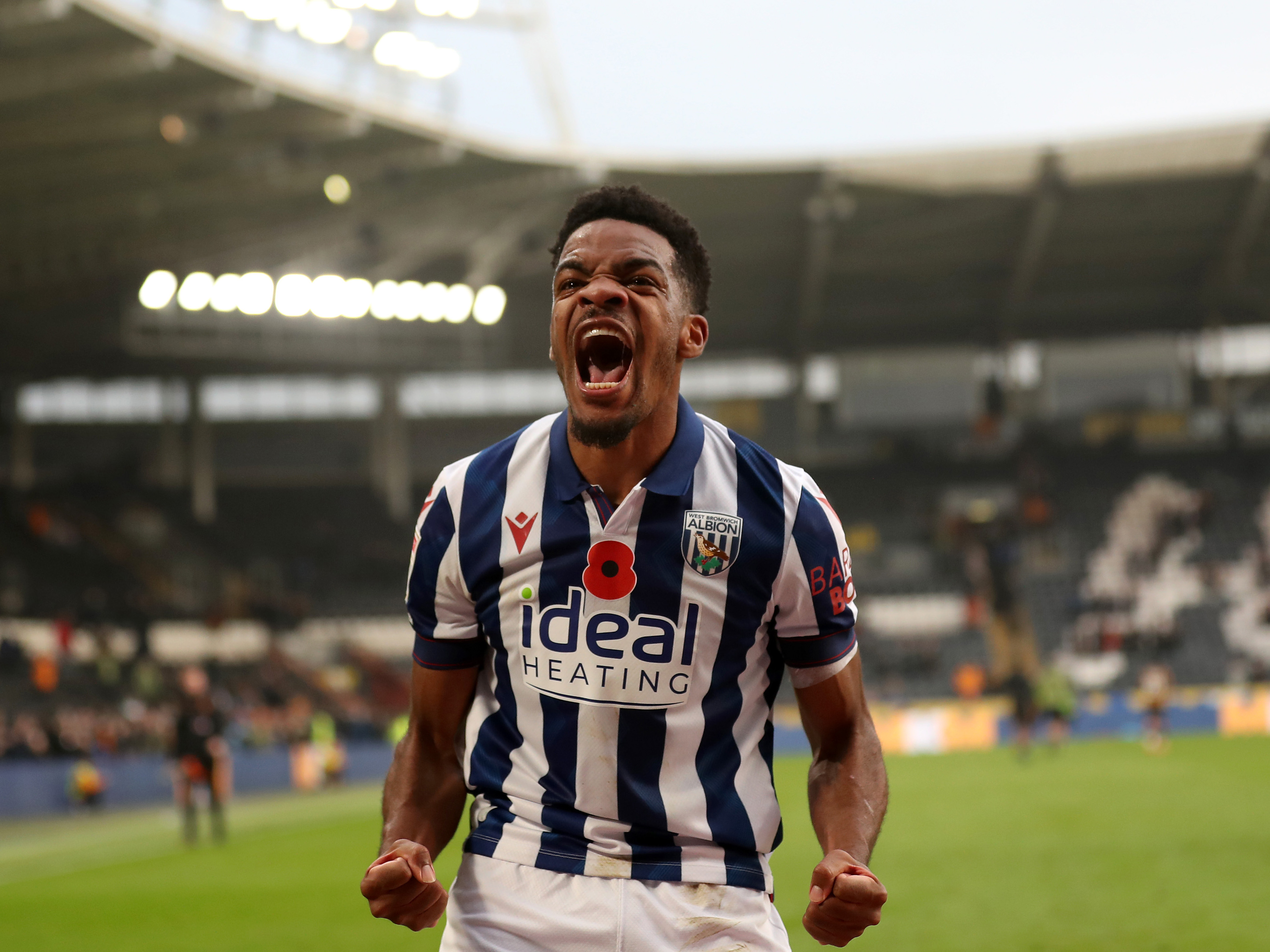 Grady Diangana celebrating a win at Hull in the home shirt with a poppy on it