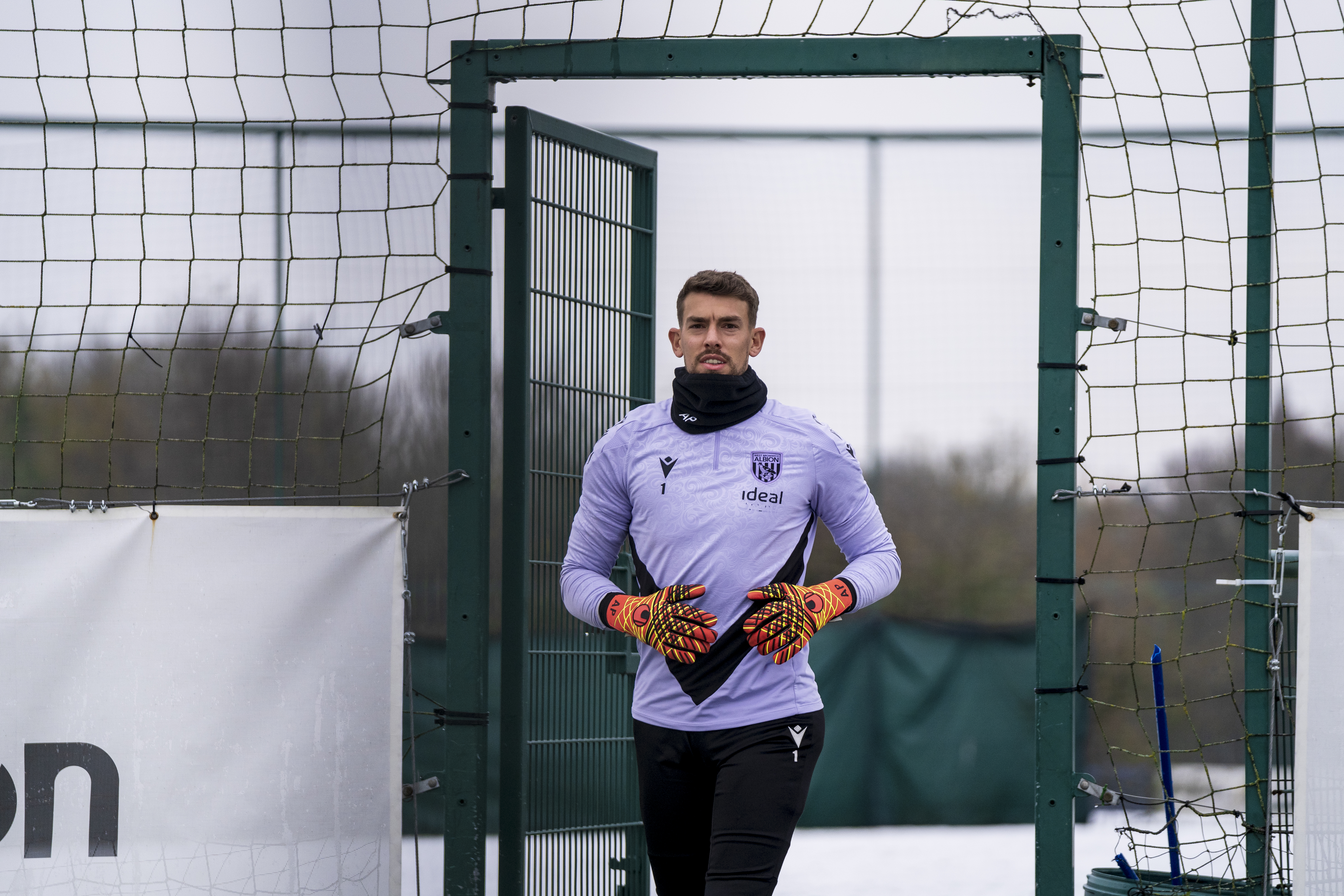 Alex Palmer walking out to training wearing a snood 