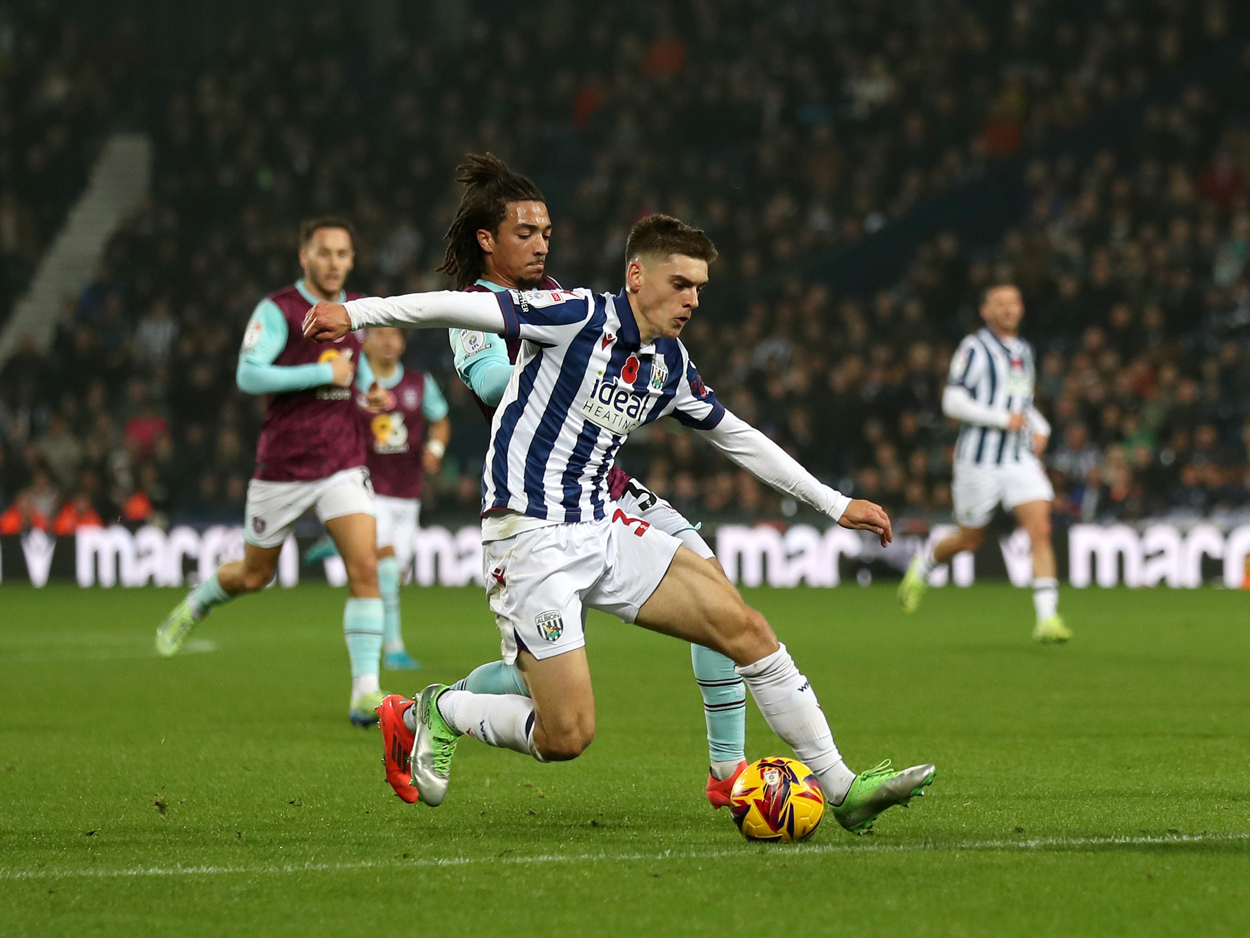 An image of Tom Fellows beating a Burnley defender