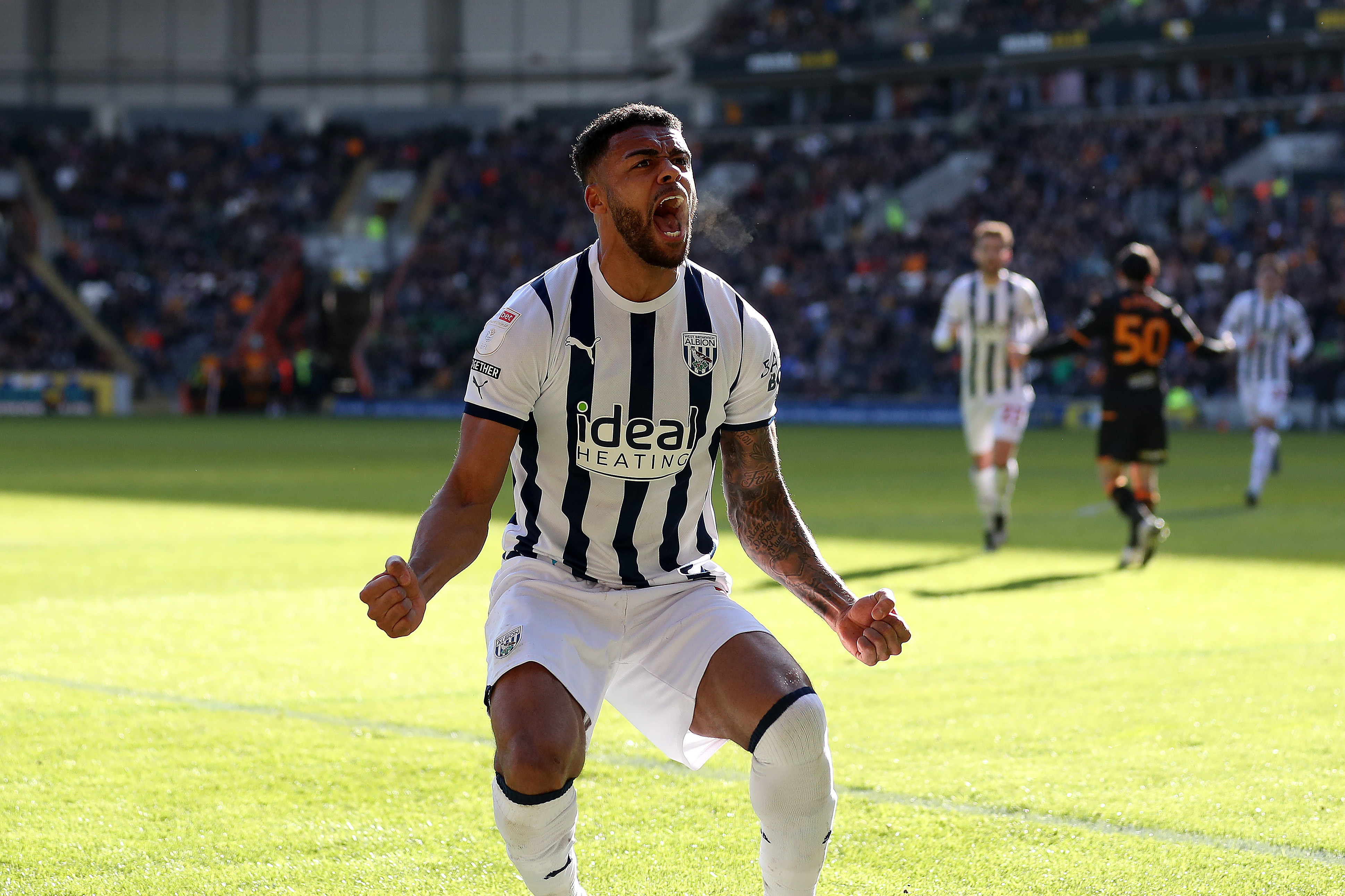 Darnell Furlong celebrates scoring at Hull in the home shirt in February 2024