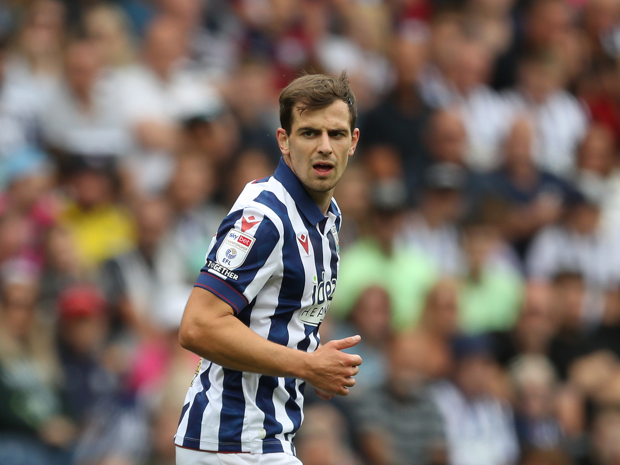 Jayson Molumby in action for Albion in the home kit 