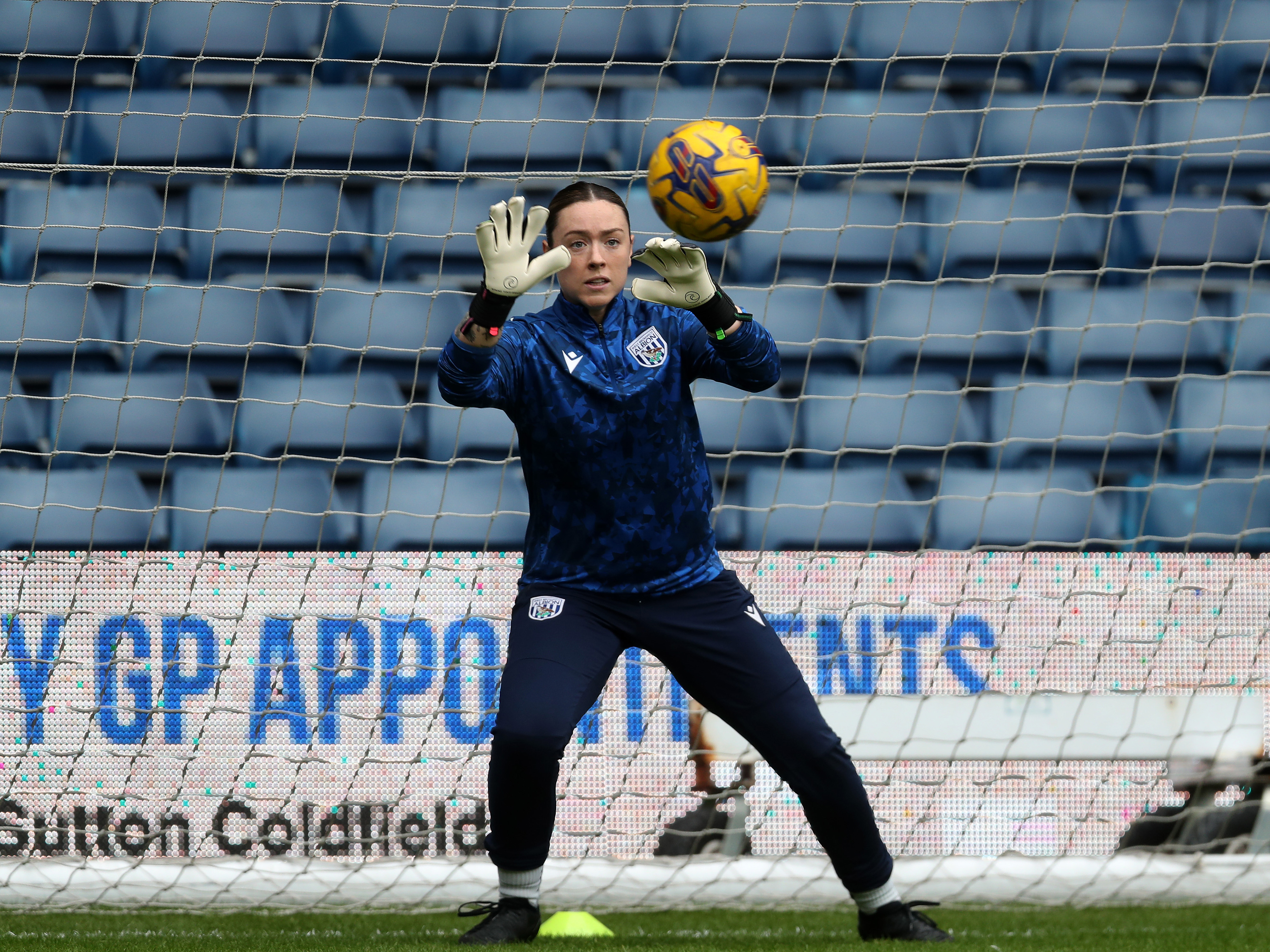 Anna Miller catching a ball during a warm-up before a game 