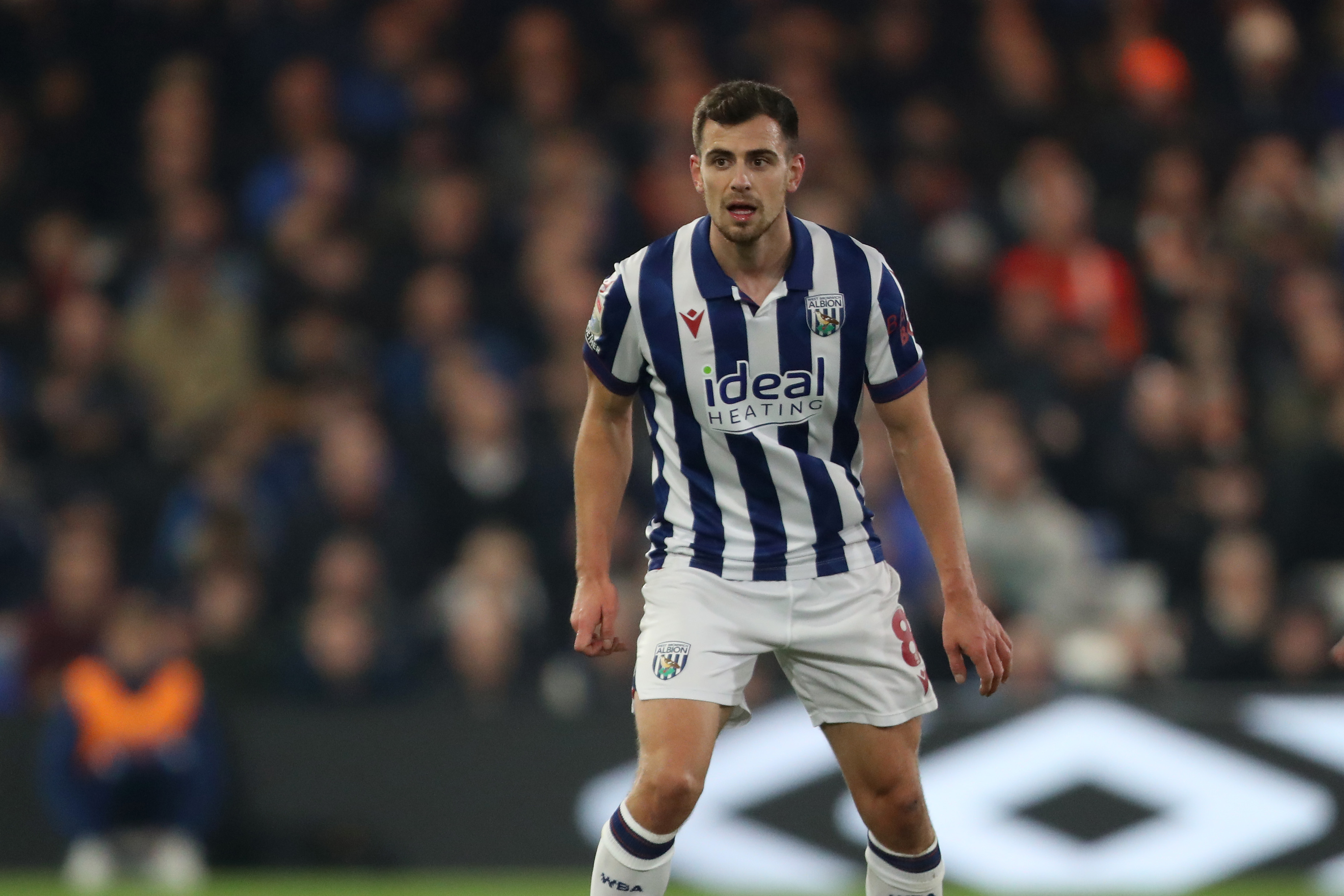 Jayson Molumby in action for Albion in the home kit 