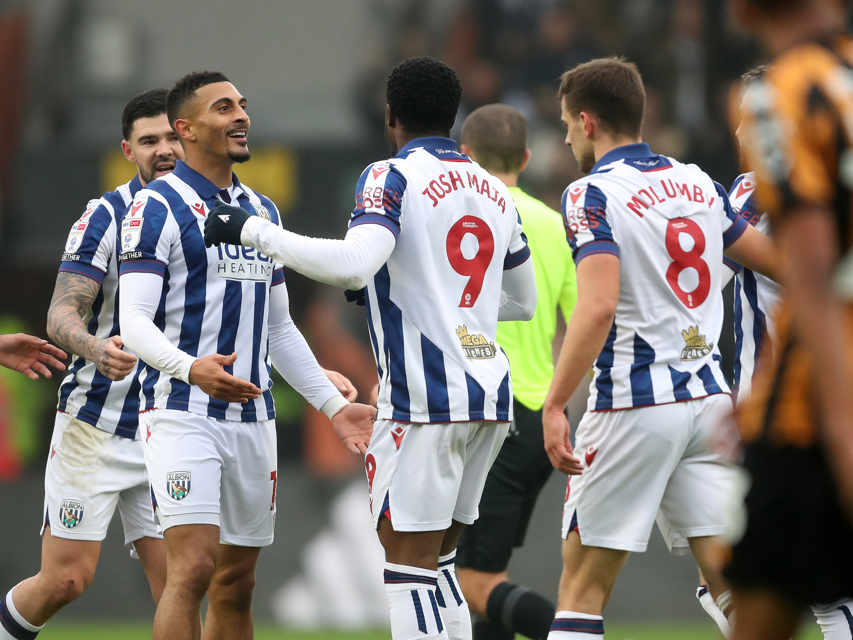 An image of Karlan Grant celebrating with his teammates after scoring at Hull