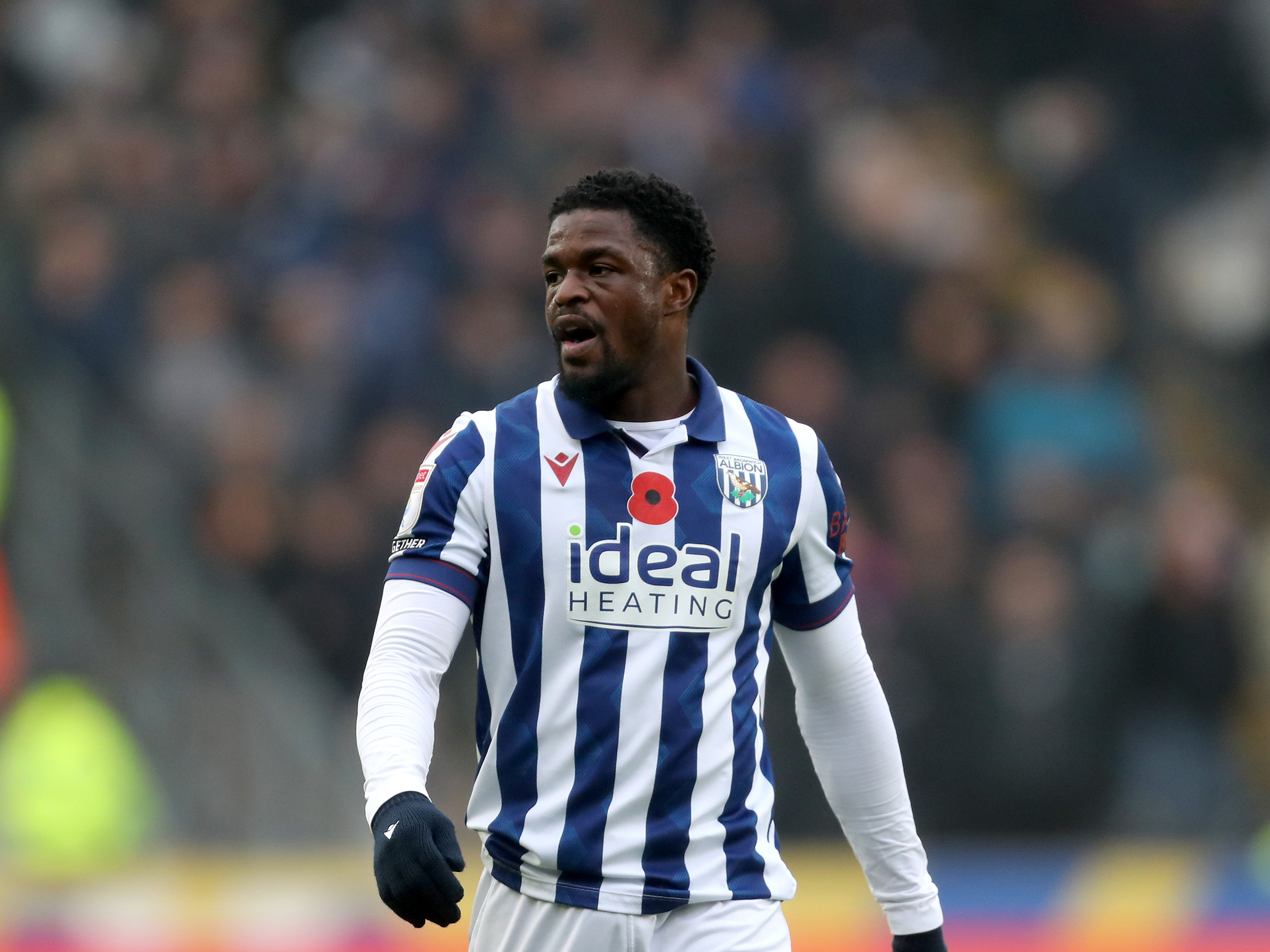 Josh Maja in action for Albion in the home kit with a poppy on it 