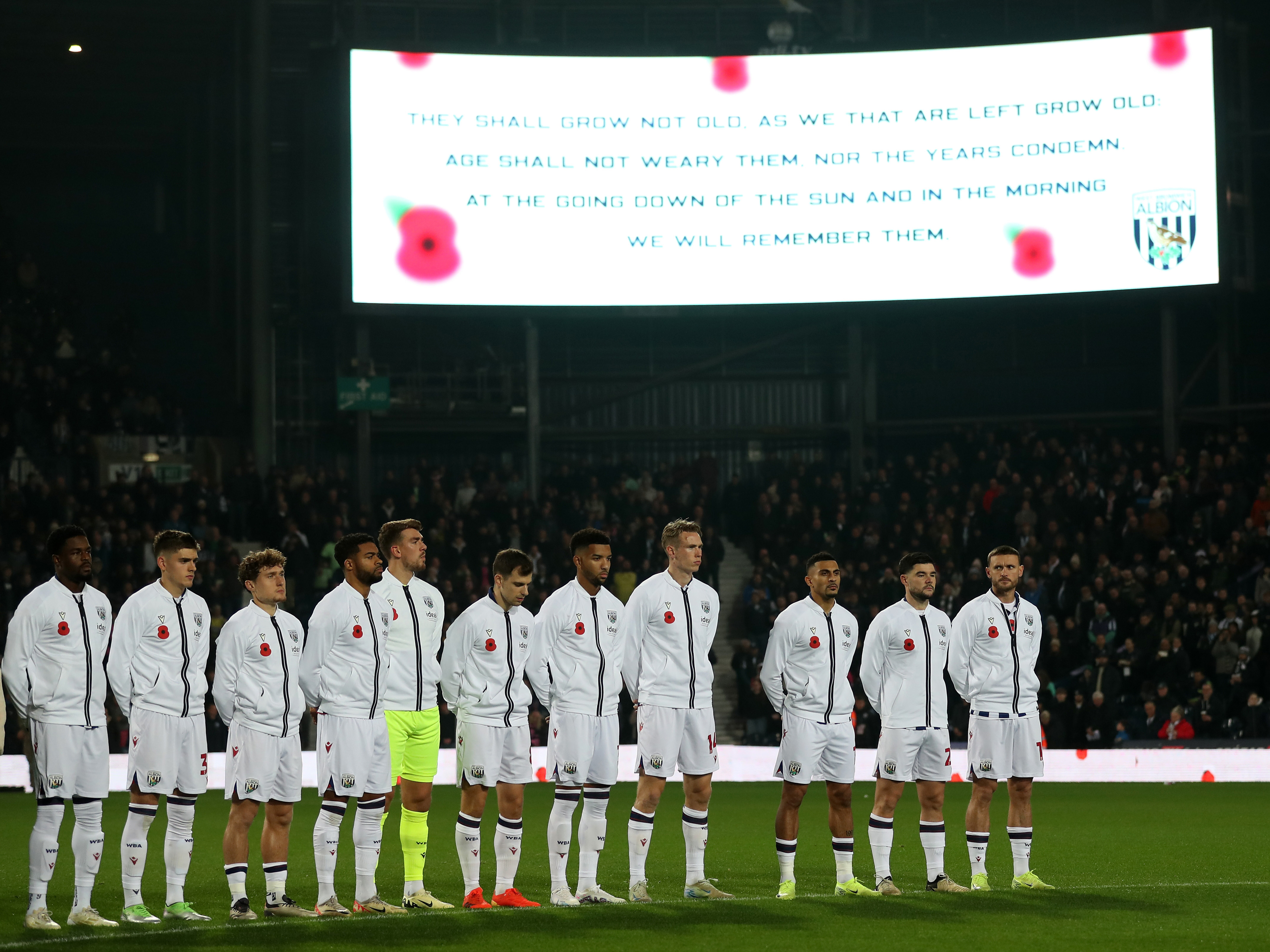 An image of Albion's team observing the last post and a moment's silence