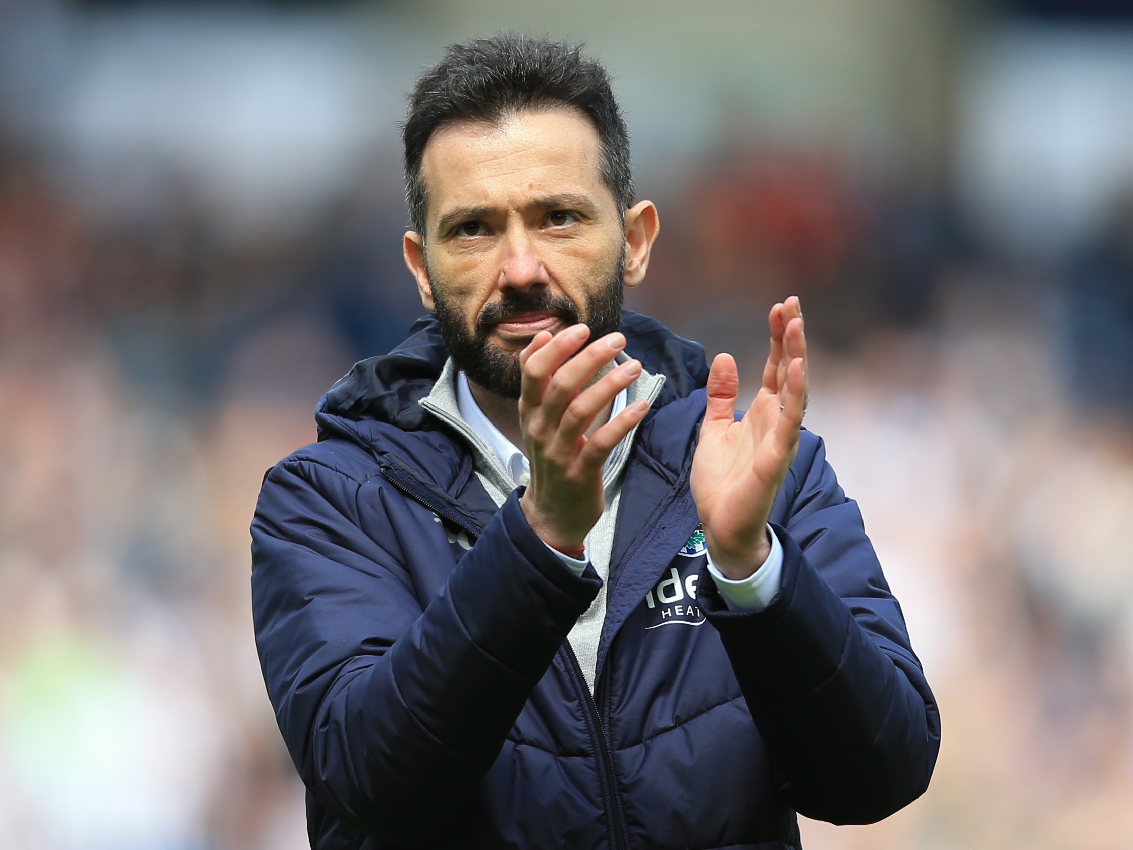 Carlos Corberán applauding Albion fans at the end of a game 