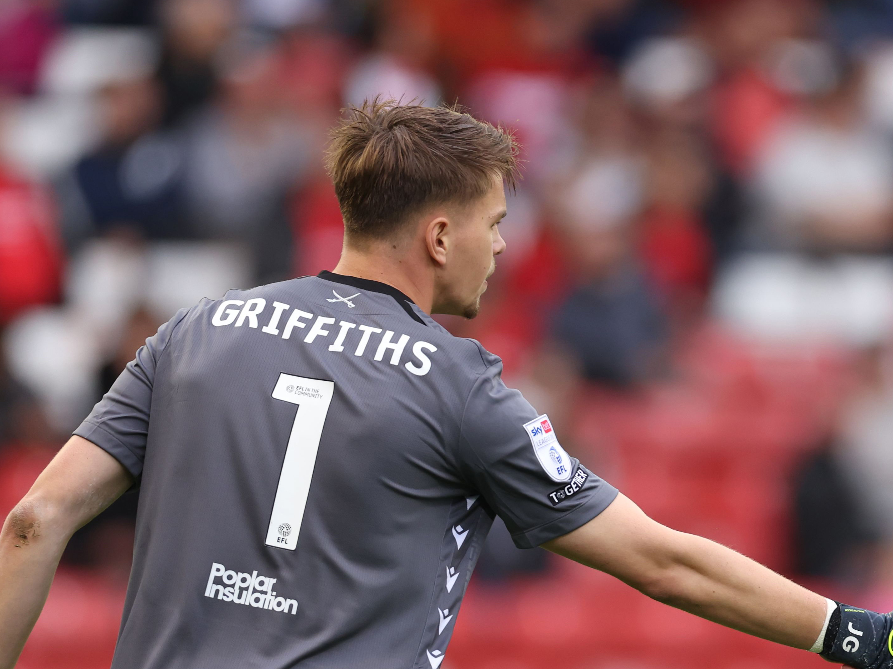 Josh Griffiths in action for Bristol Rovers with his name and No.1 on the back of his shirt 