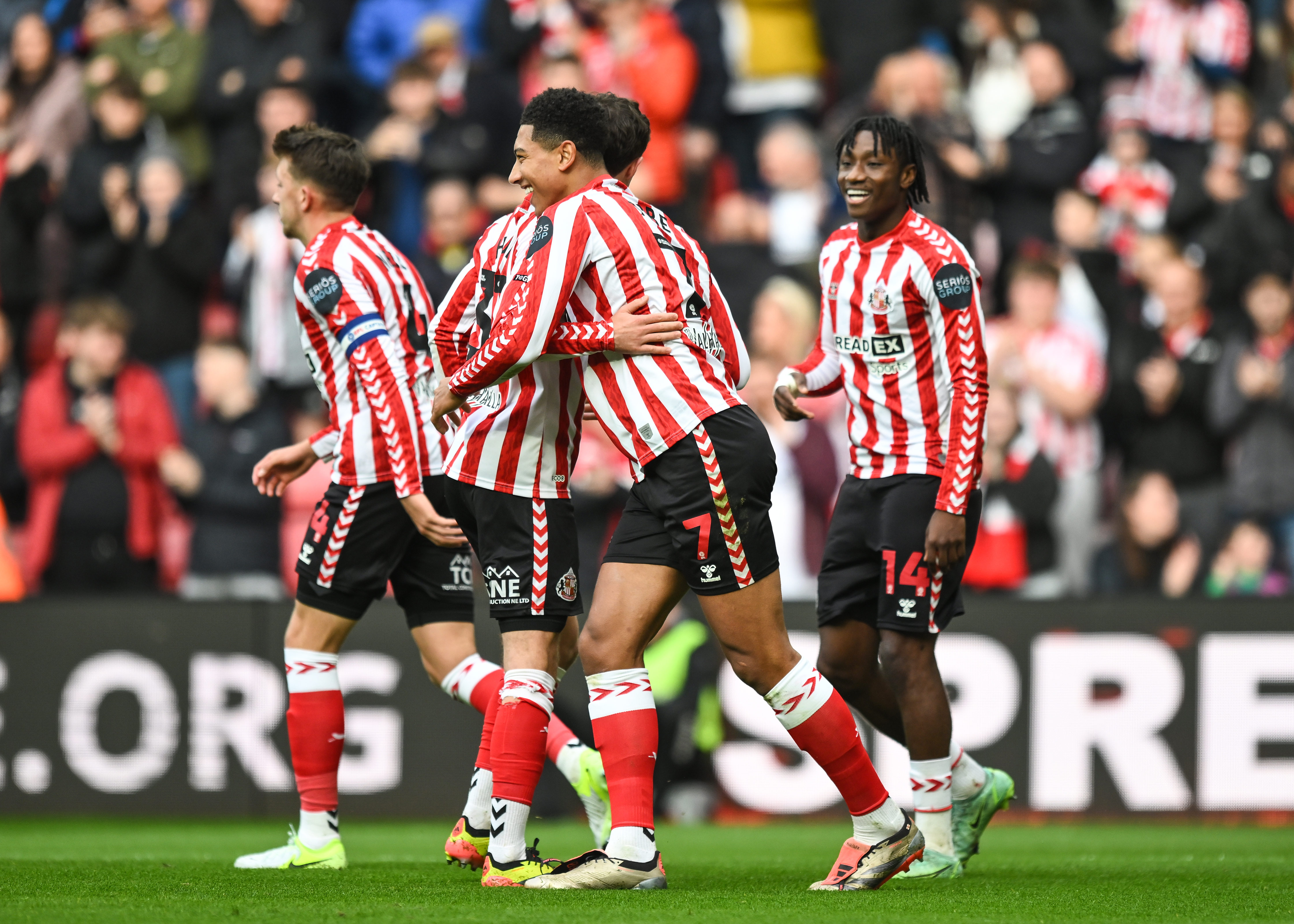 Several Sunderland players wearing the home kit celebrate a goal