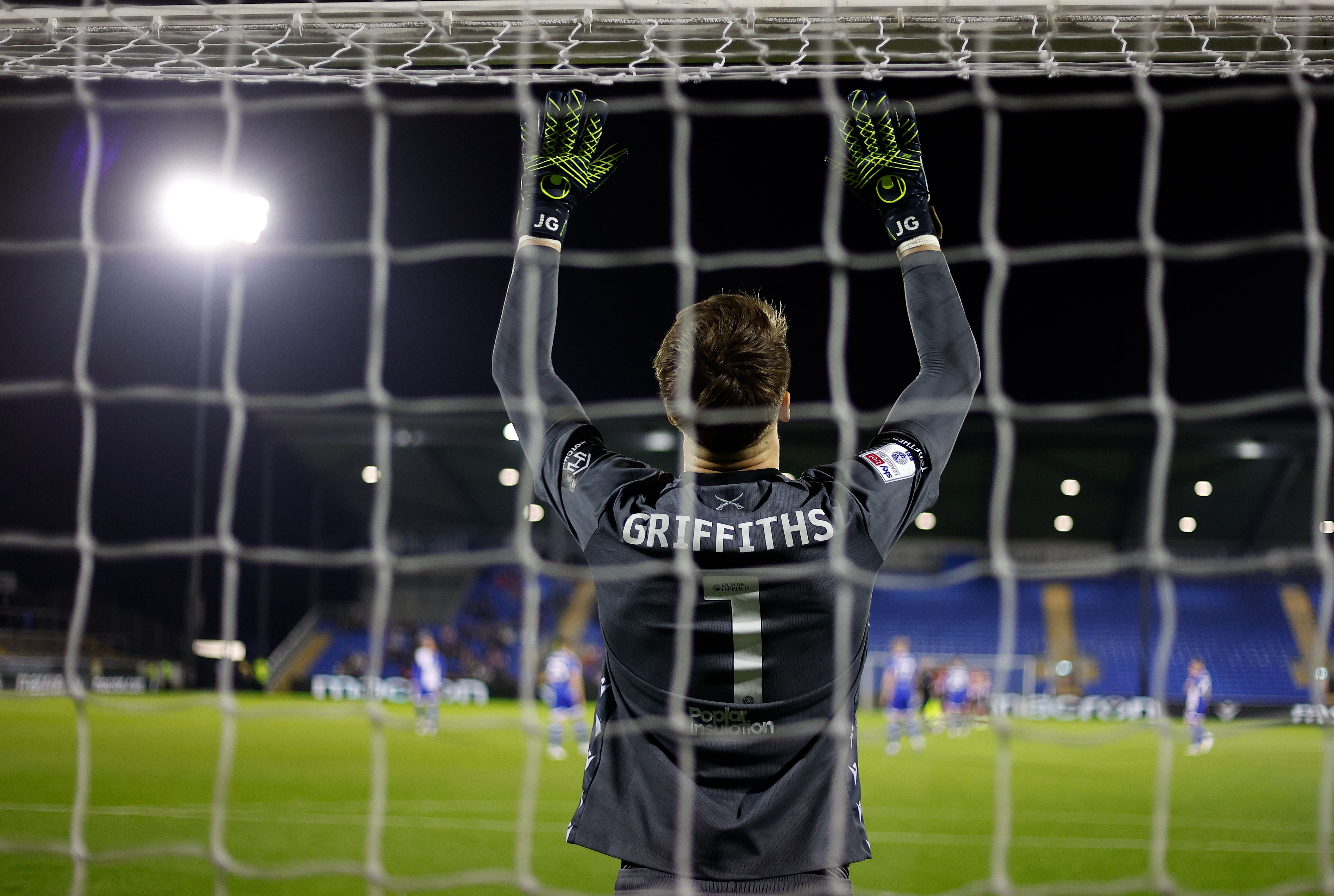 An image of the back of Josh Griffiths through a goal net with his name and No.1 while he plays for Bristol Rovers 