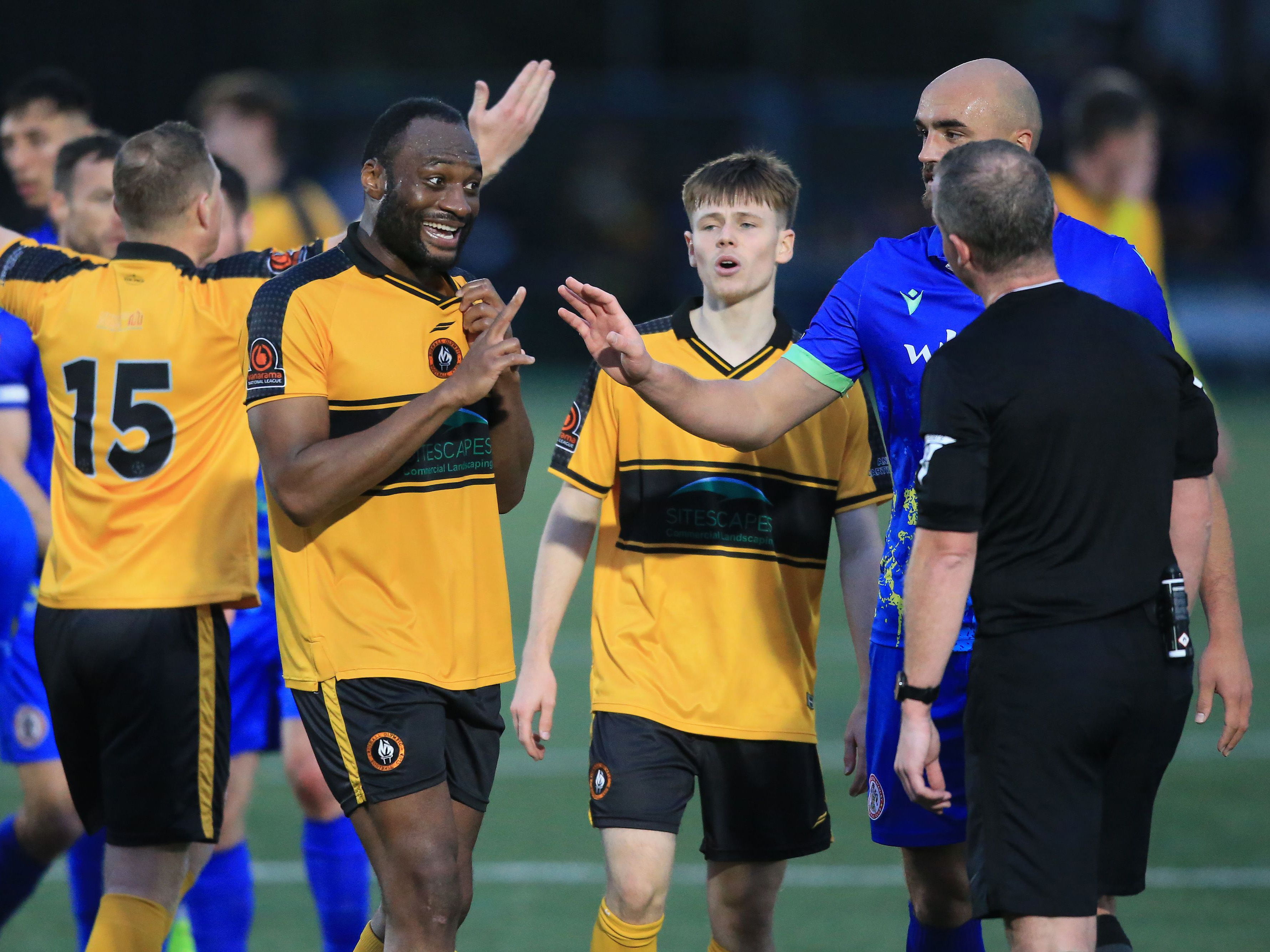 Fenton Heard and a Rushall team-mate talking to the referee during the FA cup game against Accrington 