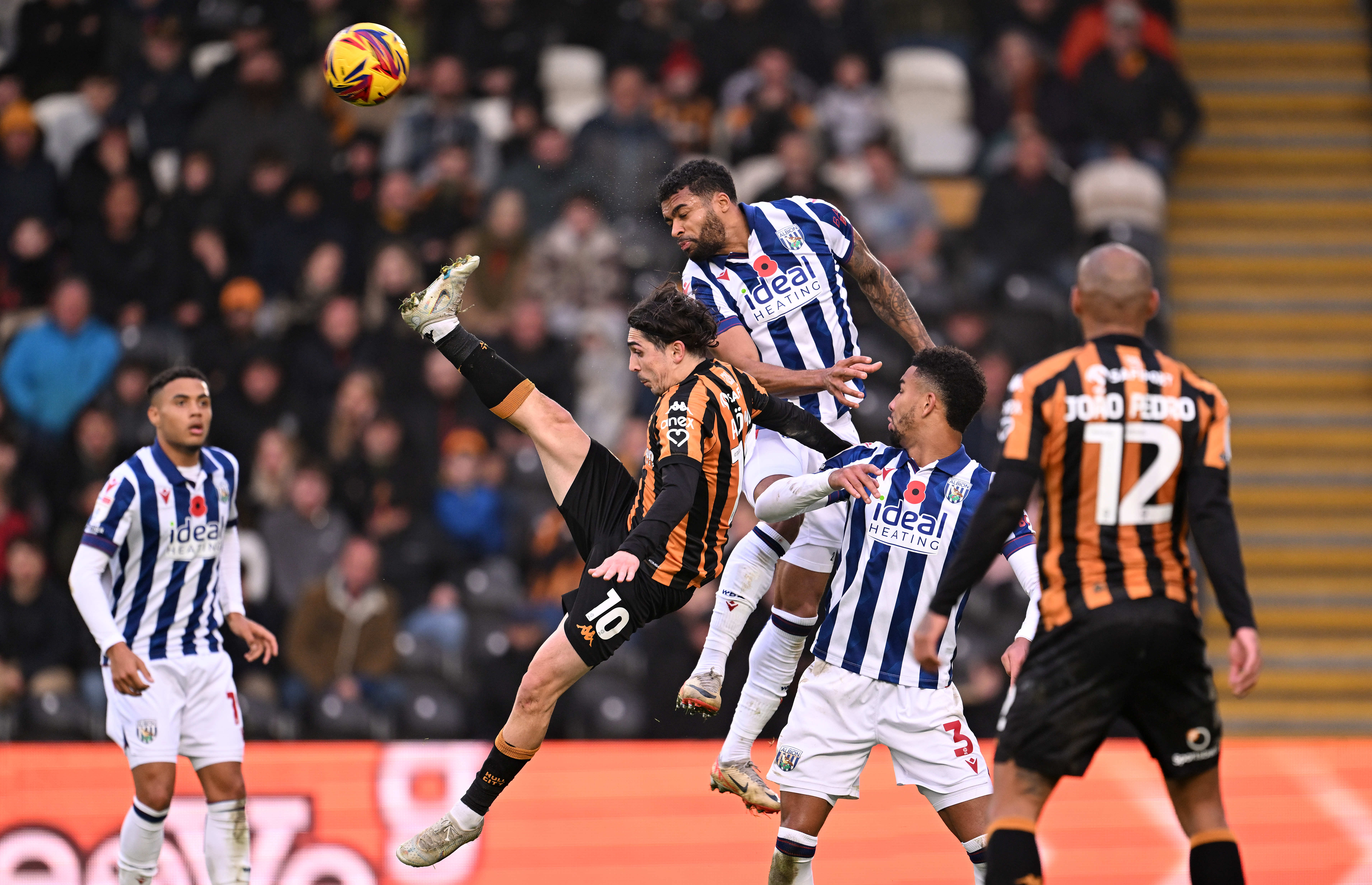 Several Hull and Albion players battle for the ball in the air