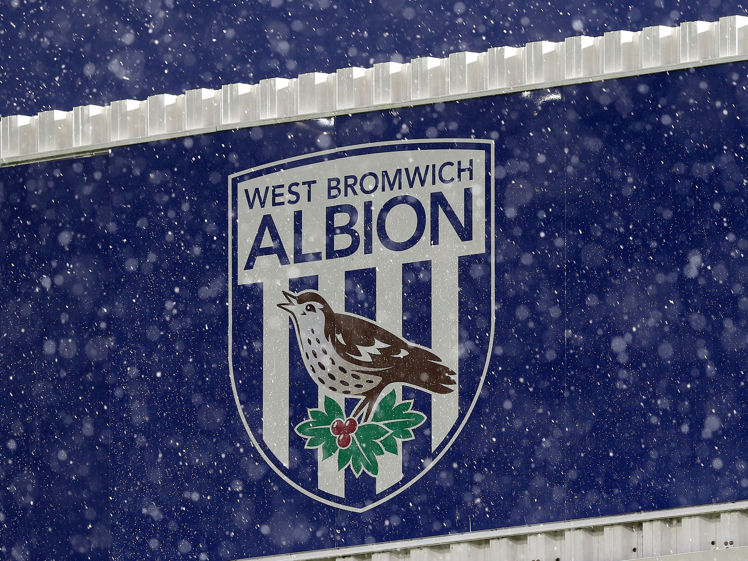 An Albion badge with snow falling around it 