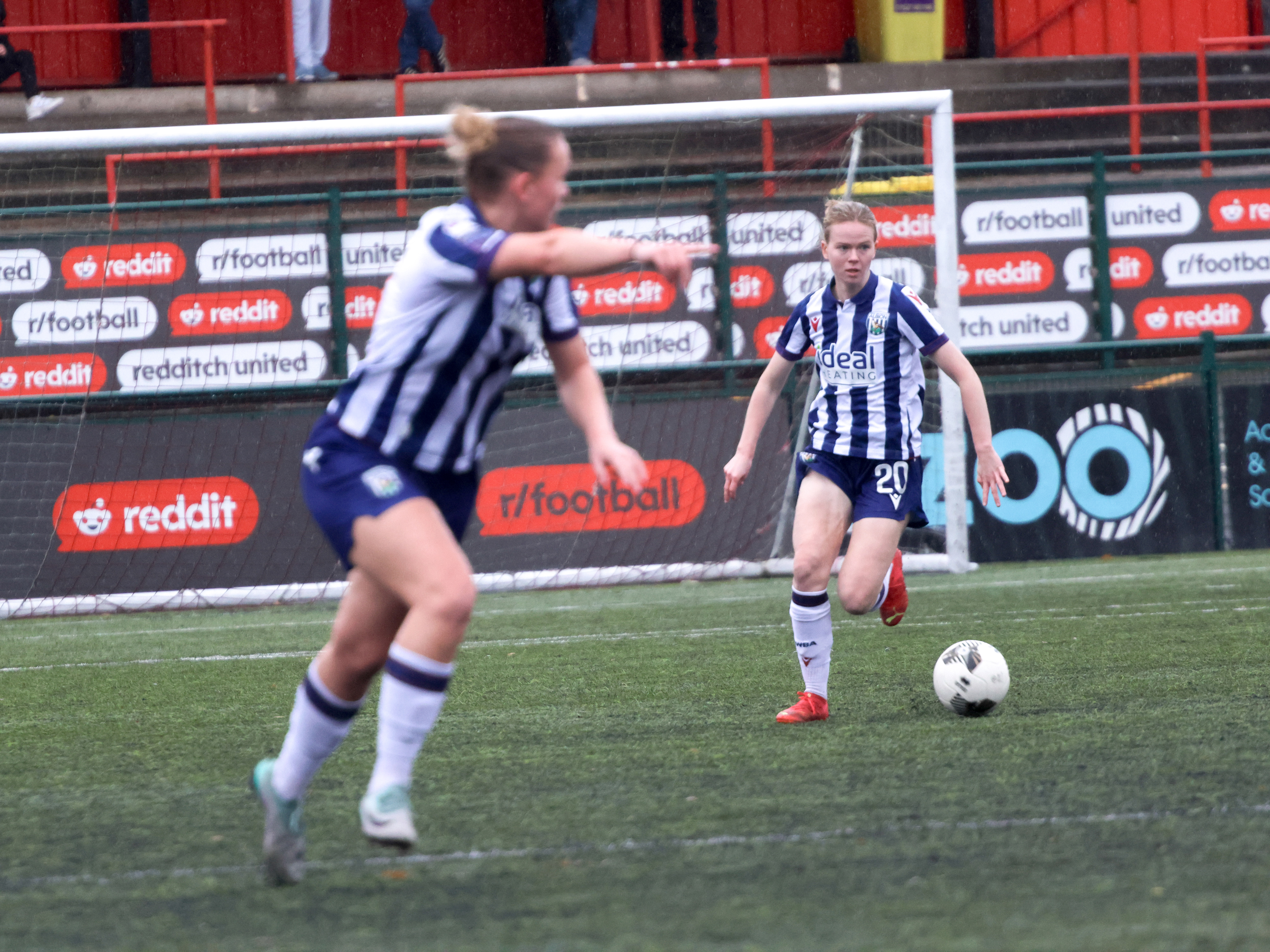 An image of Phoebe Warner playing a pass, with Marli Rhodes-Andrews in the foreground