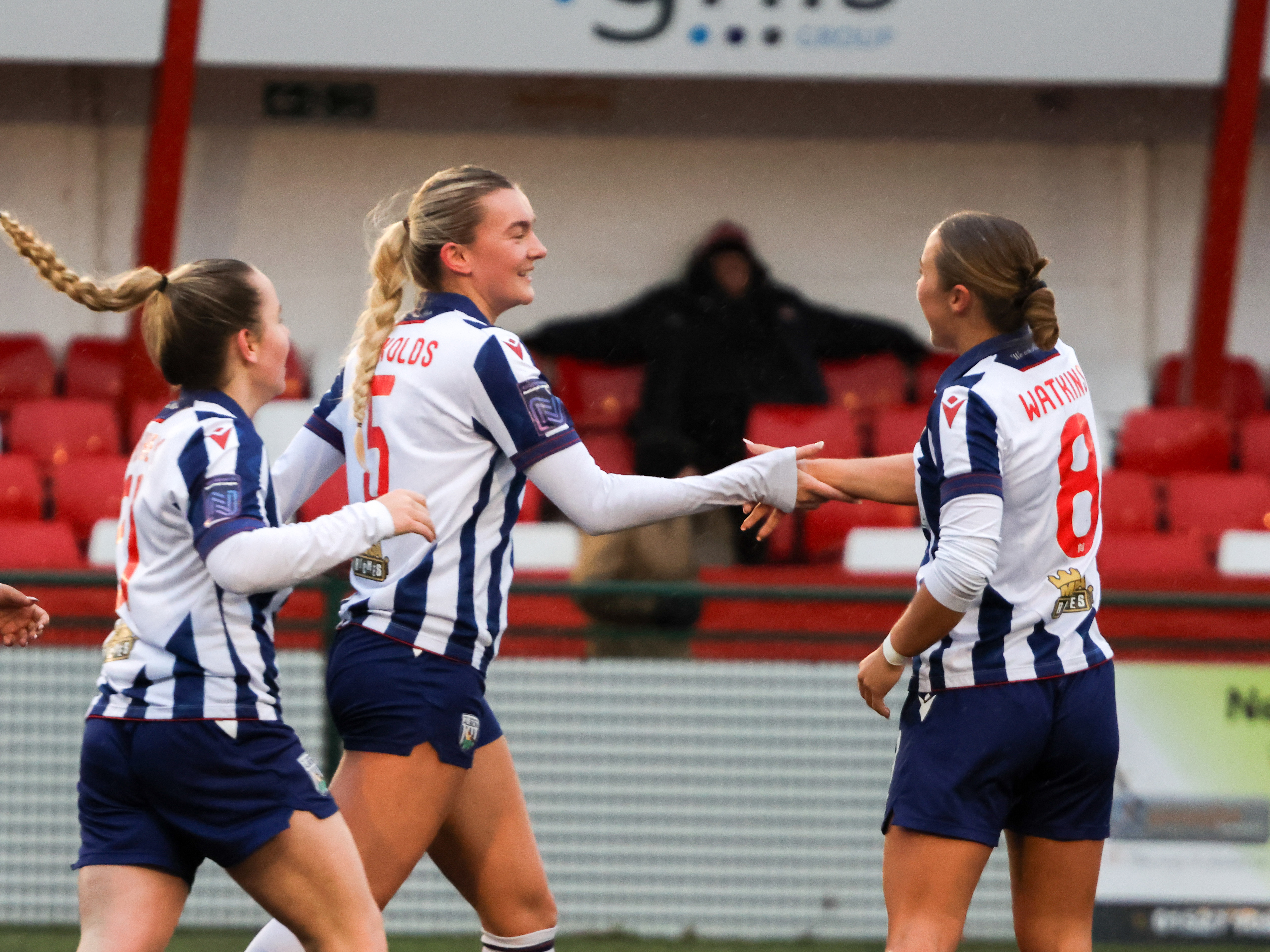 Taylor Reynolds and Seren Watkins celebrate a goal while wearing the home kit 