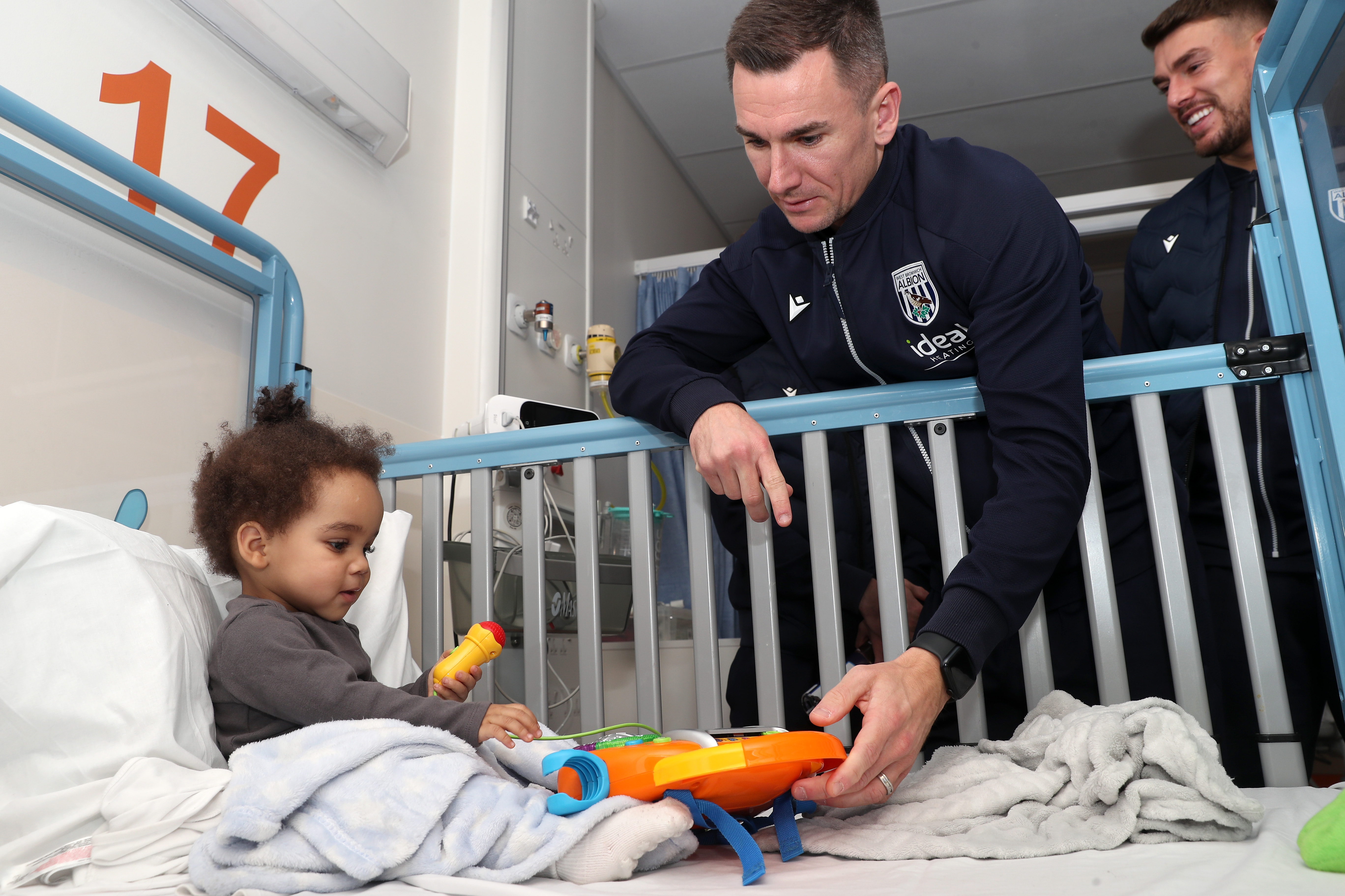 Jed Wallace interacts with a young patient at Midlands Metropolitan University Hospital 