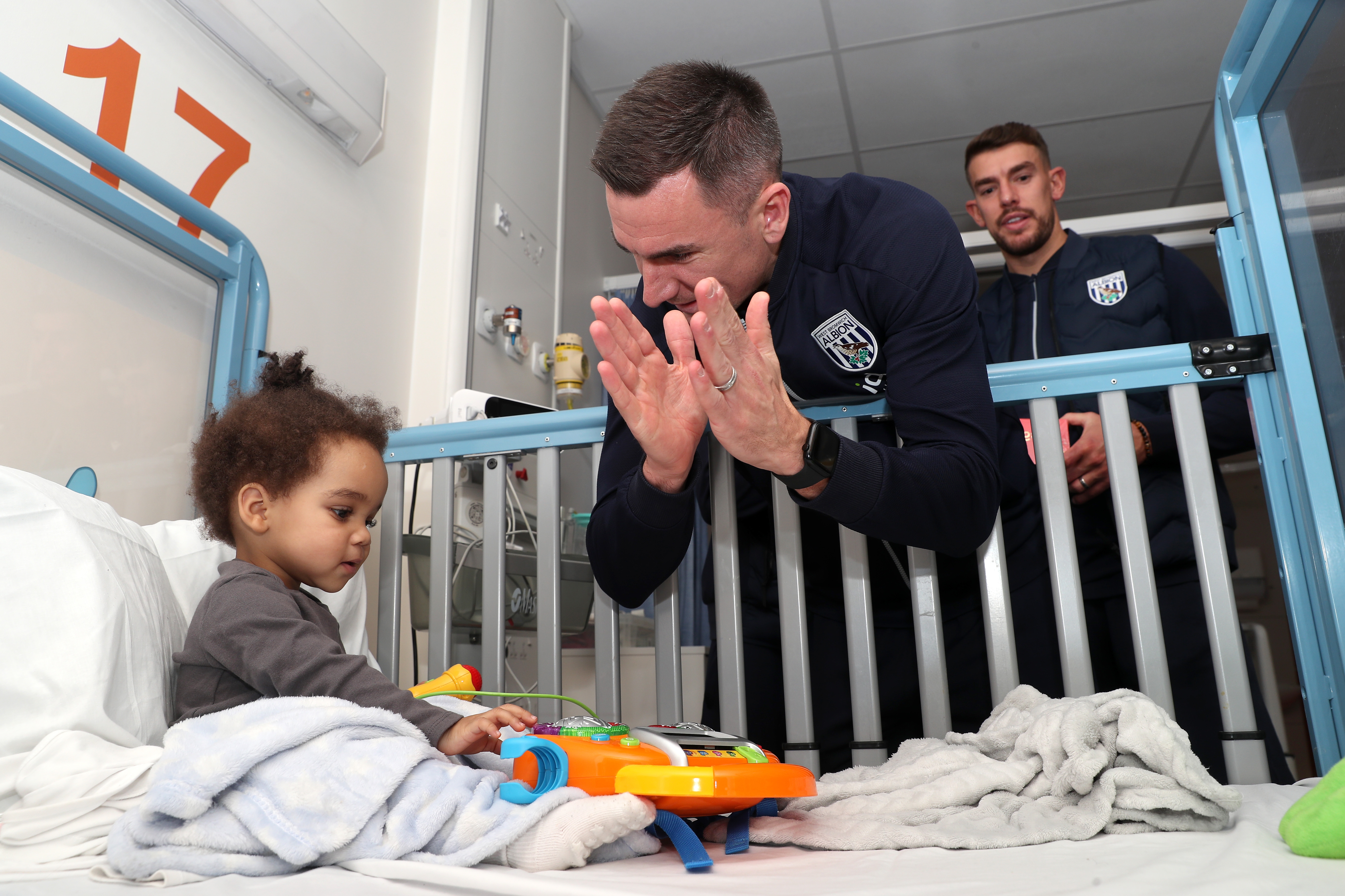 Jed Wallace interacts with a young patient at Midlands Metropolitan University Hospital 