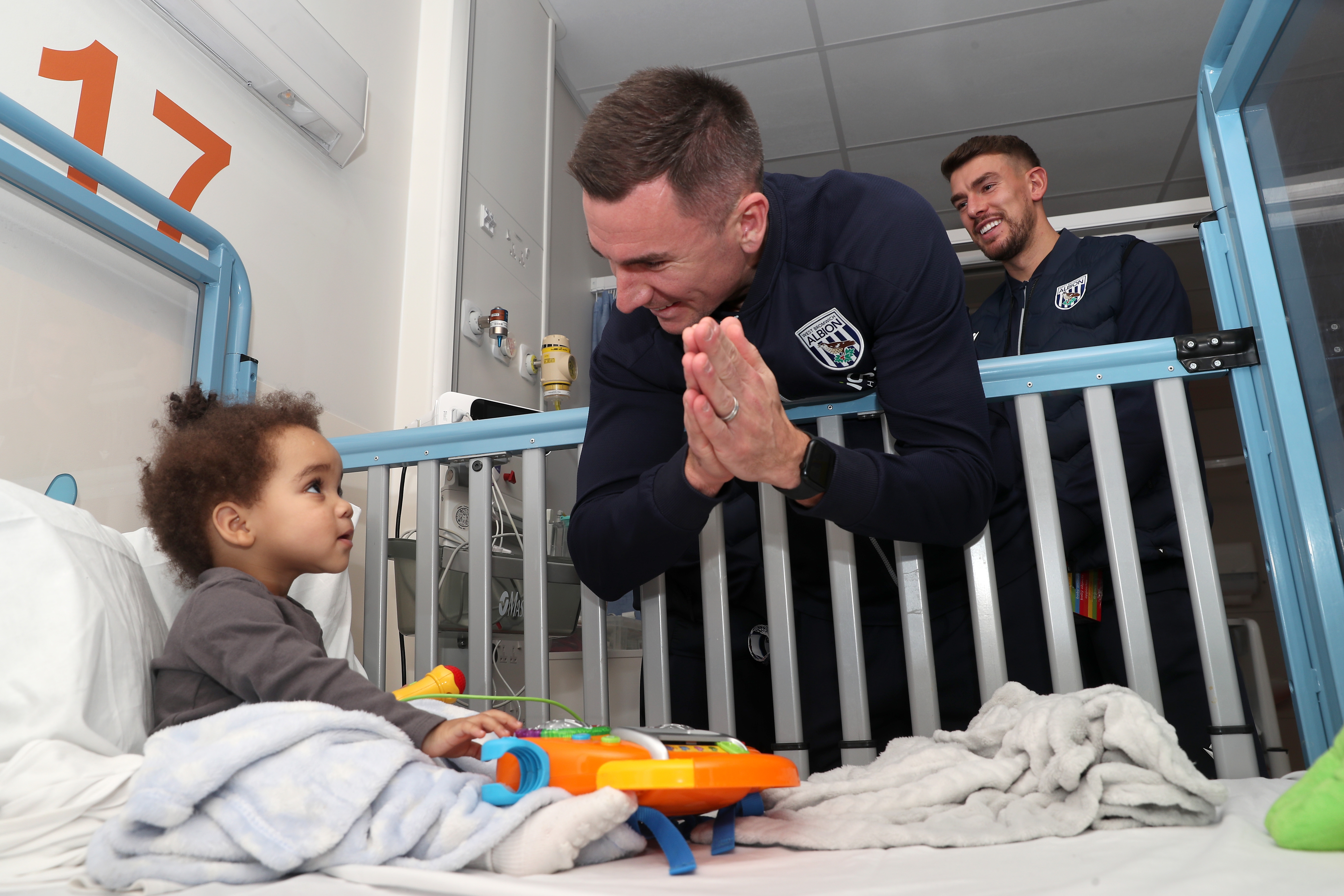 Jed Wallace interacts with a young patient at Midlands Metropolitan University Hospital 