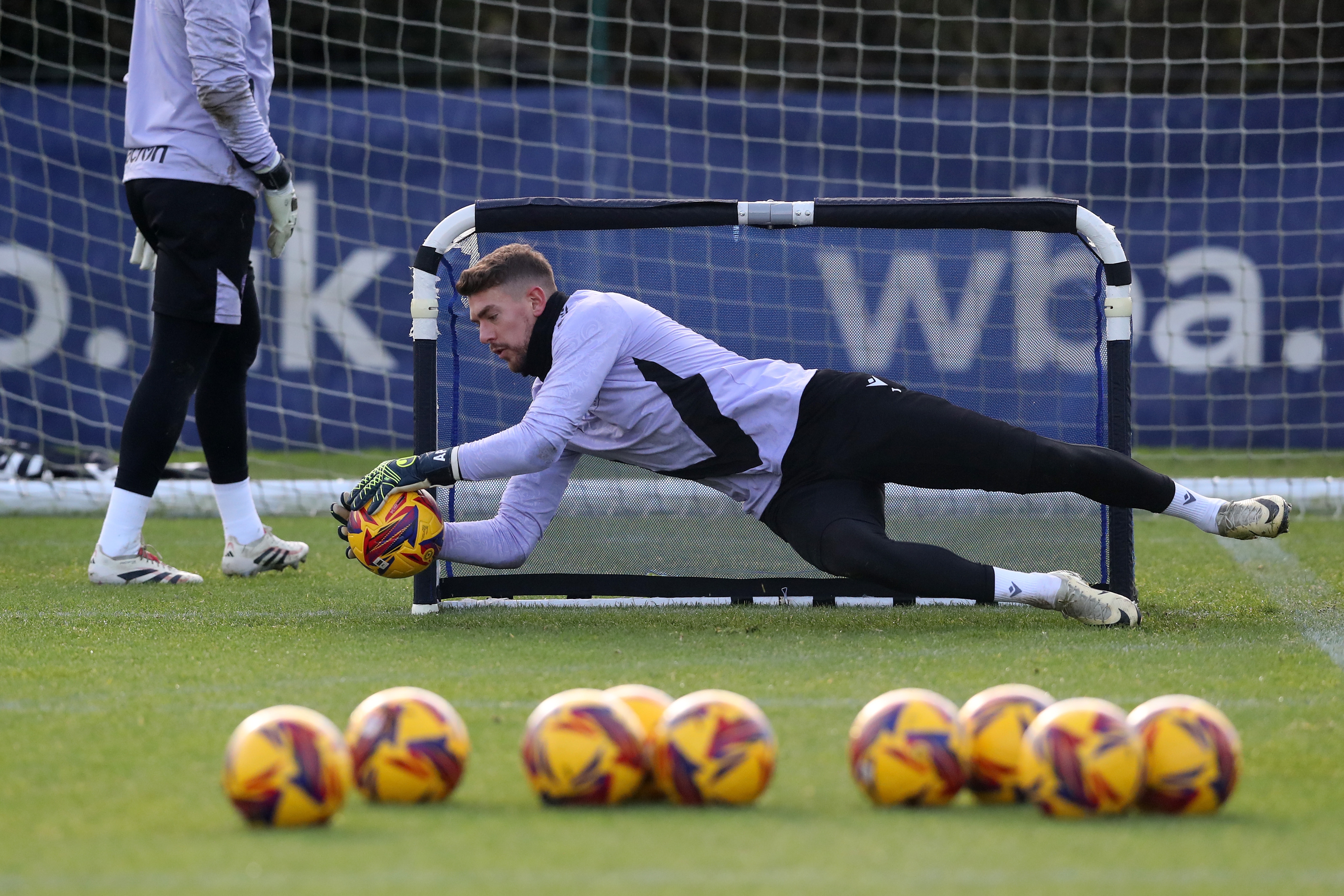 Alex Palmer diving down low to catch a ball 