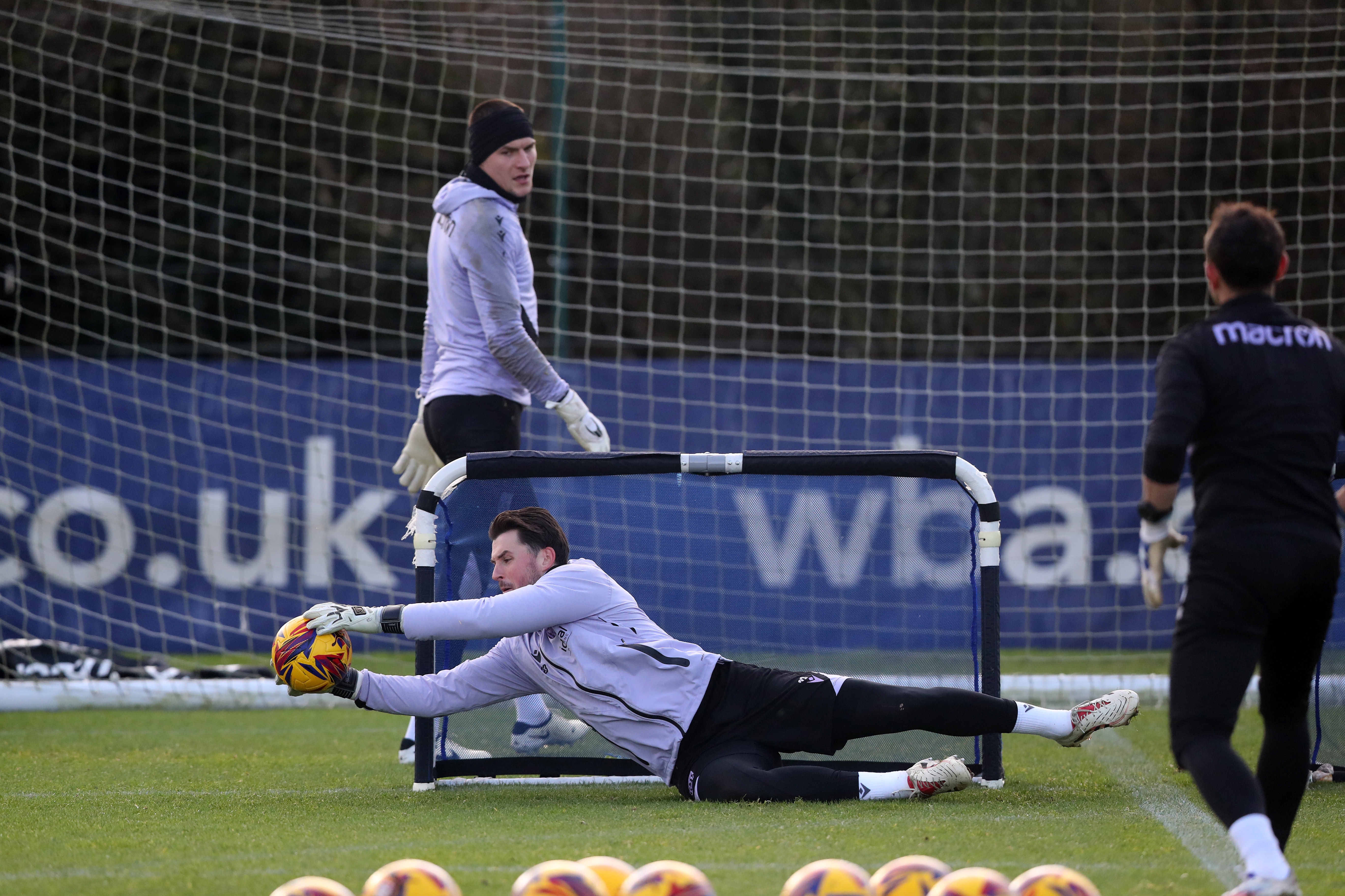 Joe Wildsmith diving down low to catch a ball in training 