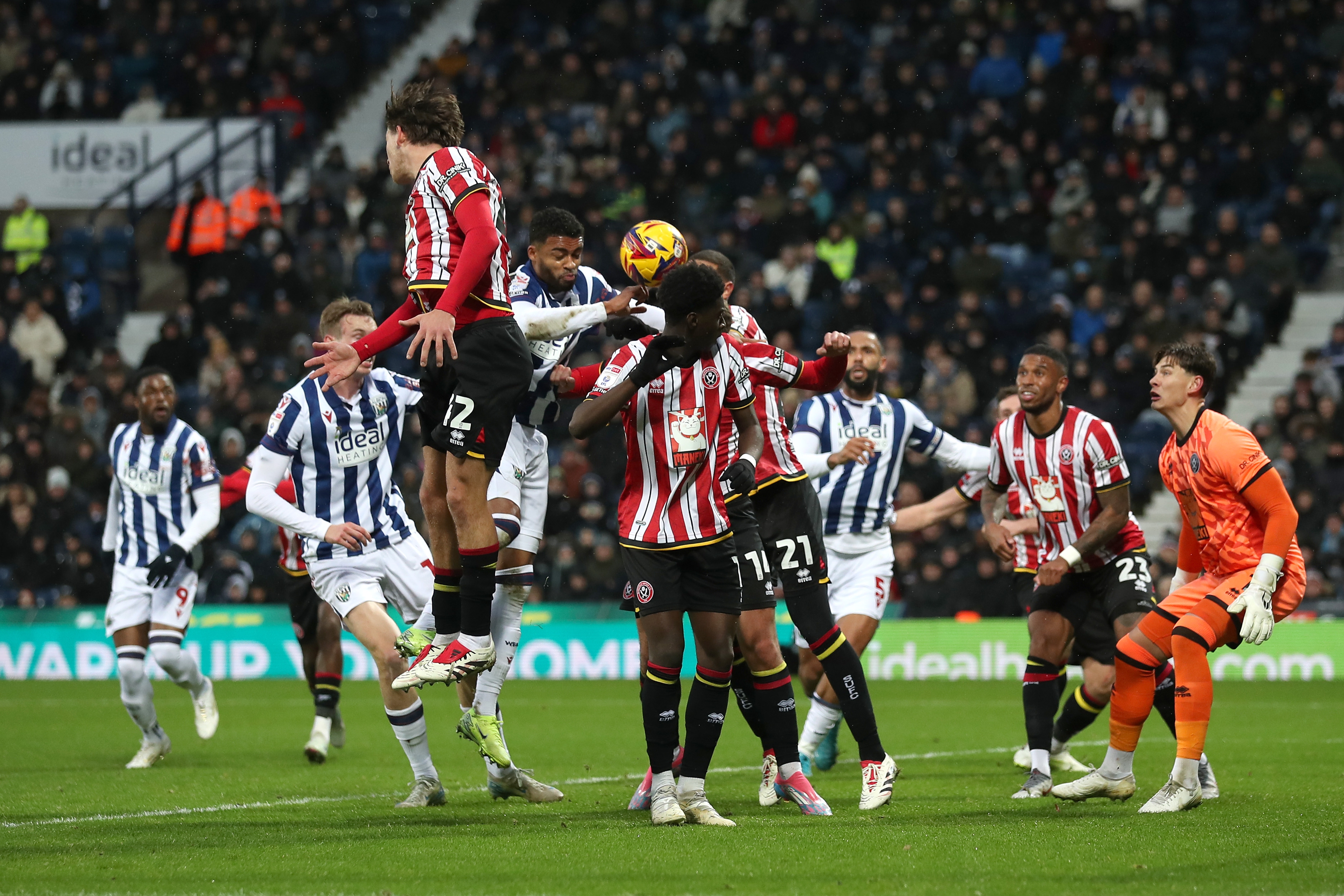 Several players try and win a header for Albion and Sheffield United 