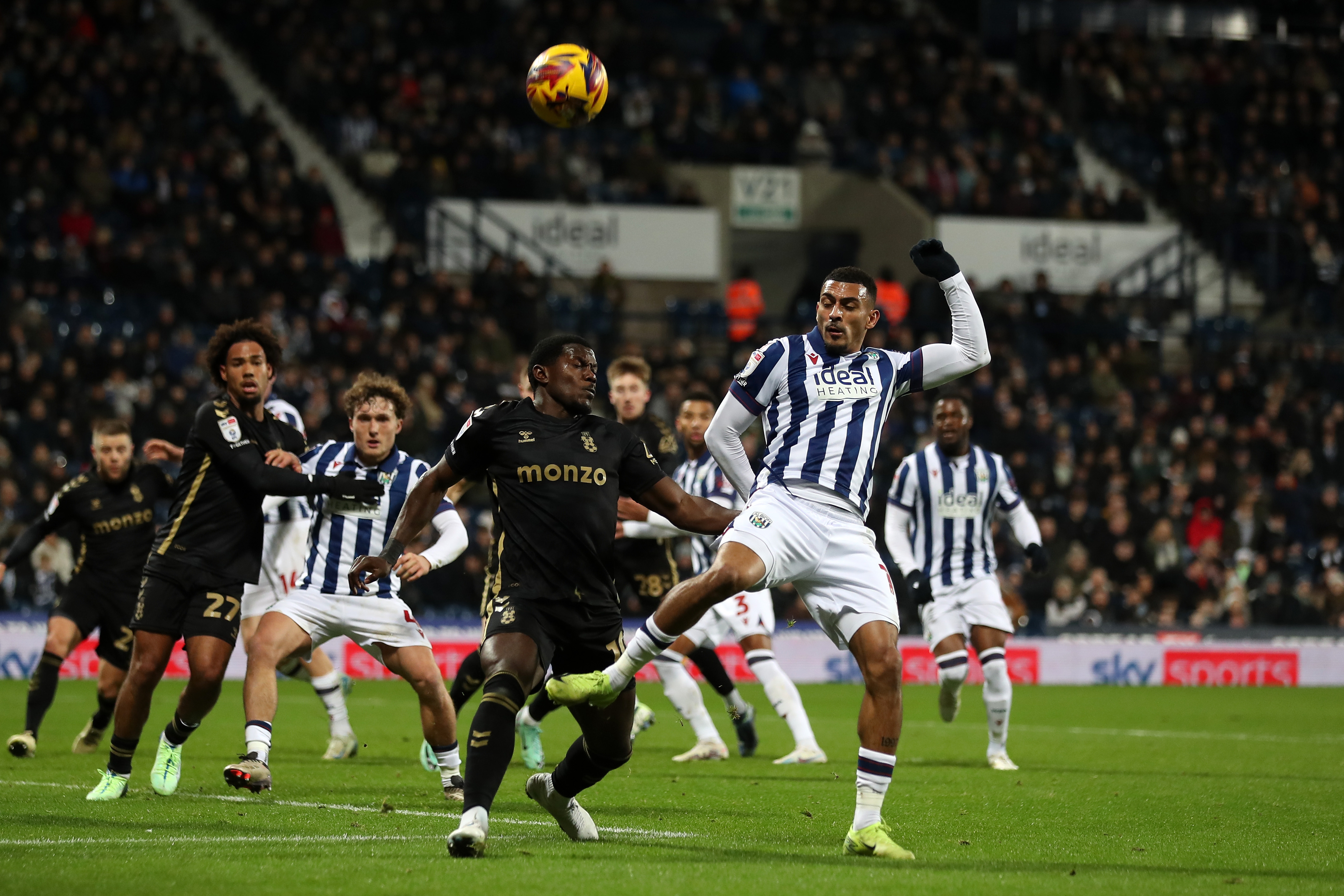 Several players try and make contact with the ball in the penalty area 