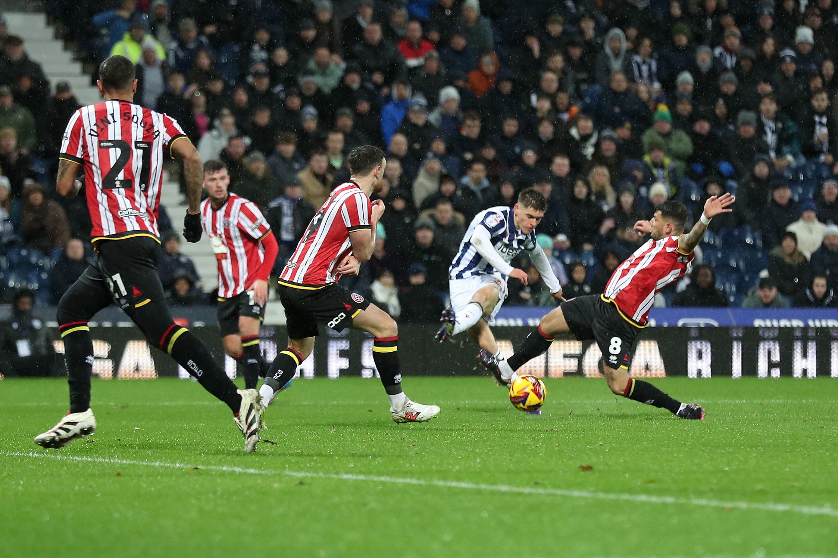 Tom Fellows shoots through a crowd against Sheffield United 