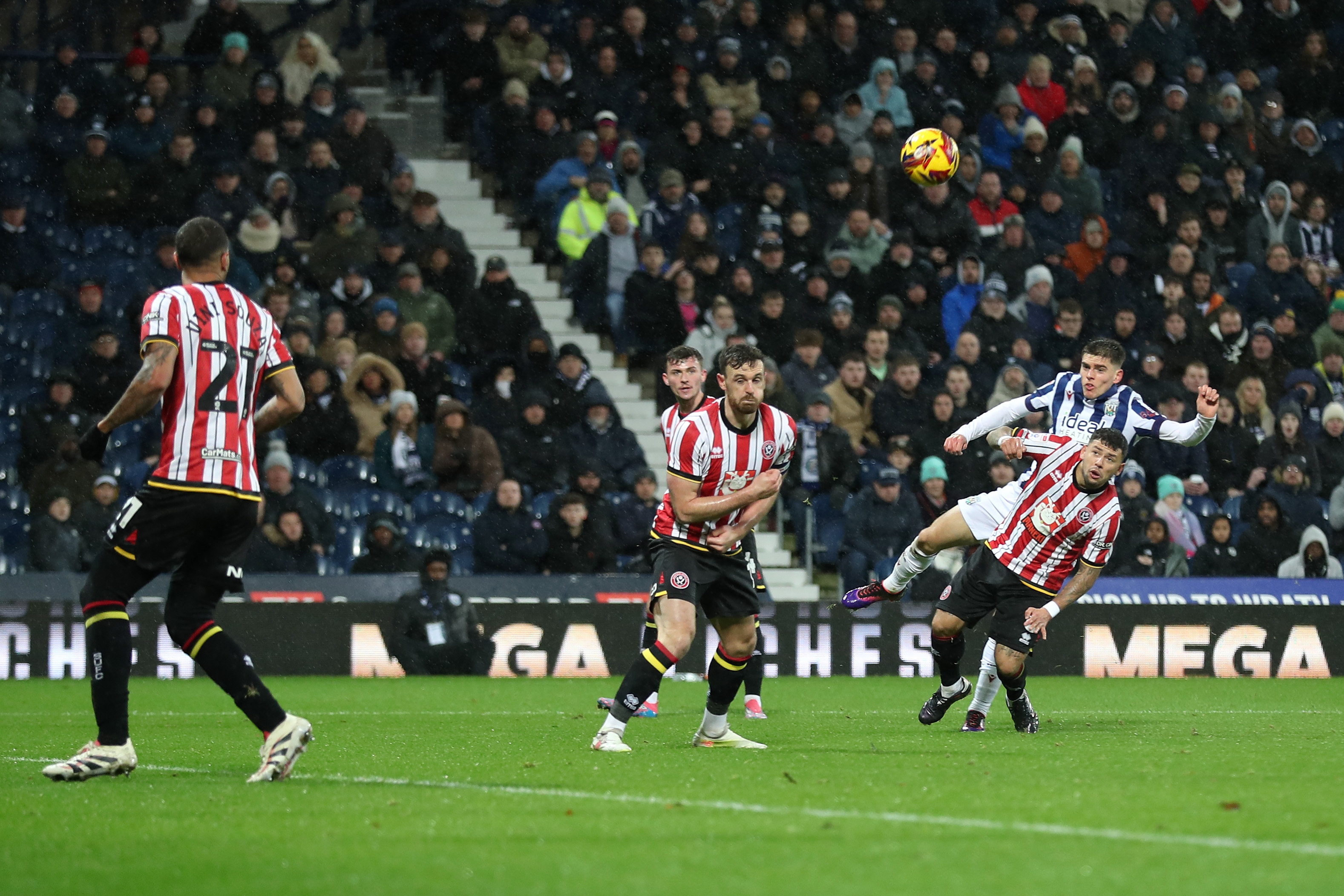 Tom Fellows shoots through a crowd against Sheffield United 