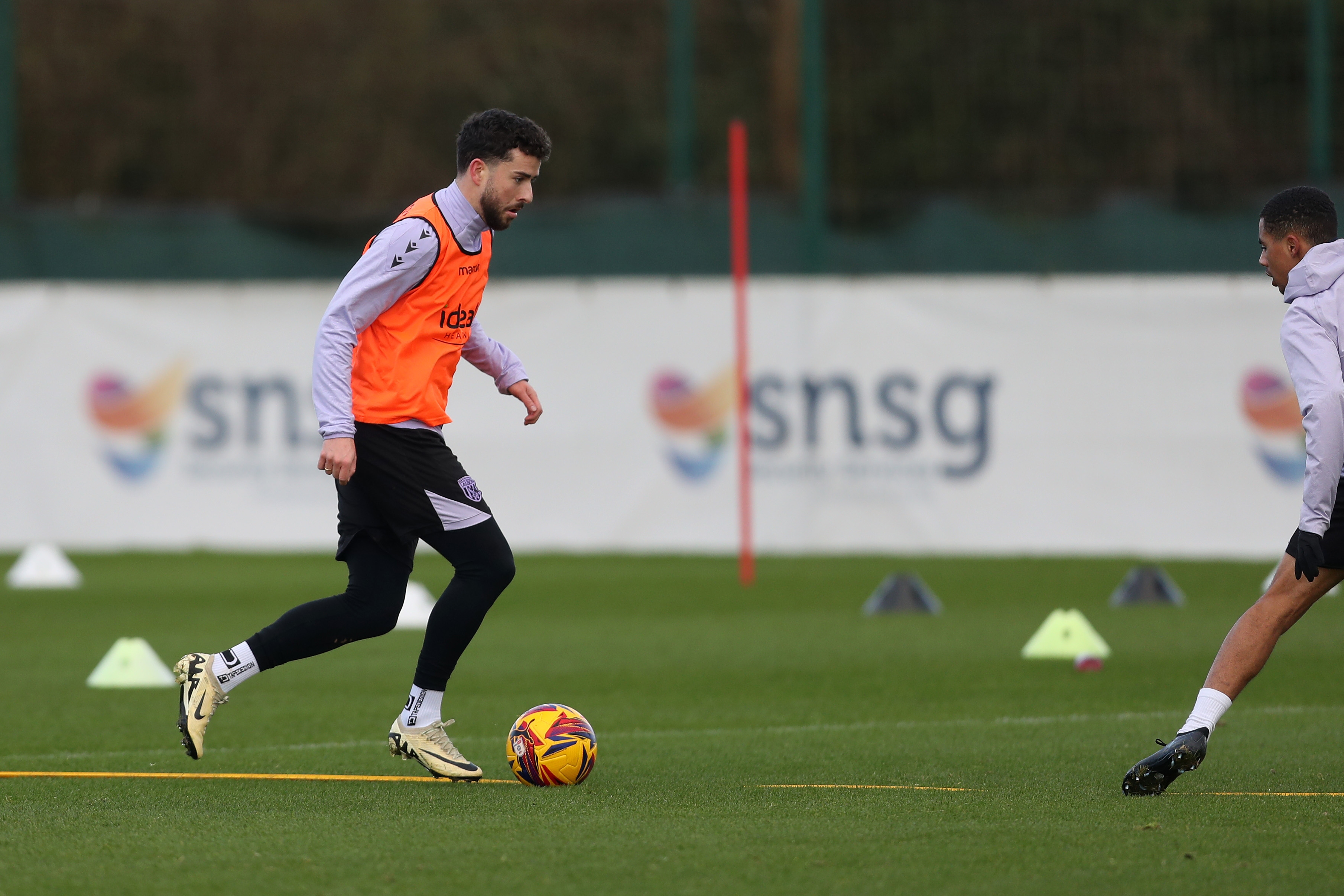 Mikey Johnston running with the ball during training 