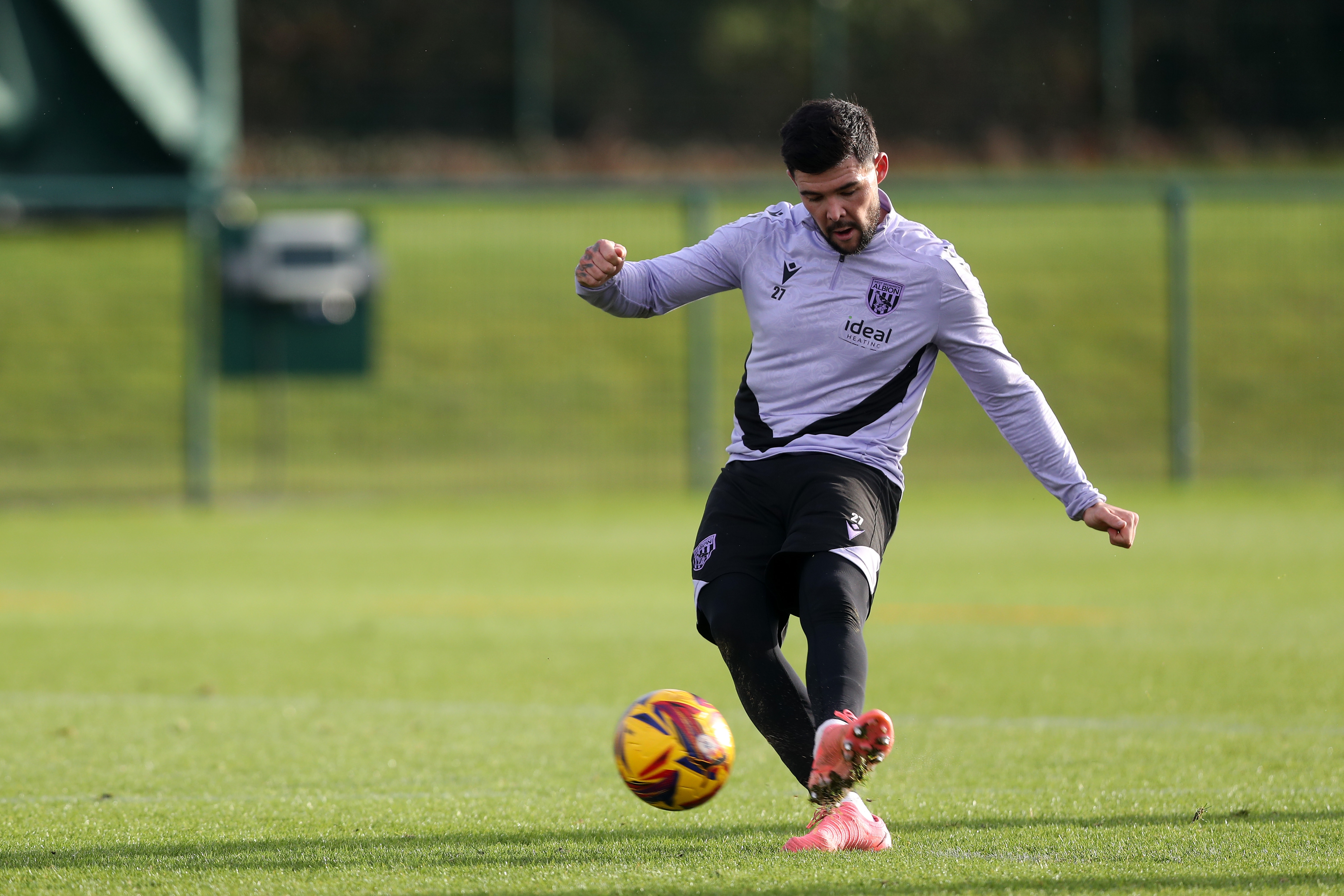 Alex Mowatt striking the ball during training 