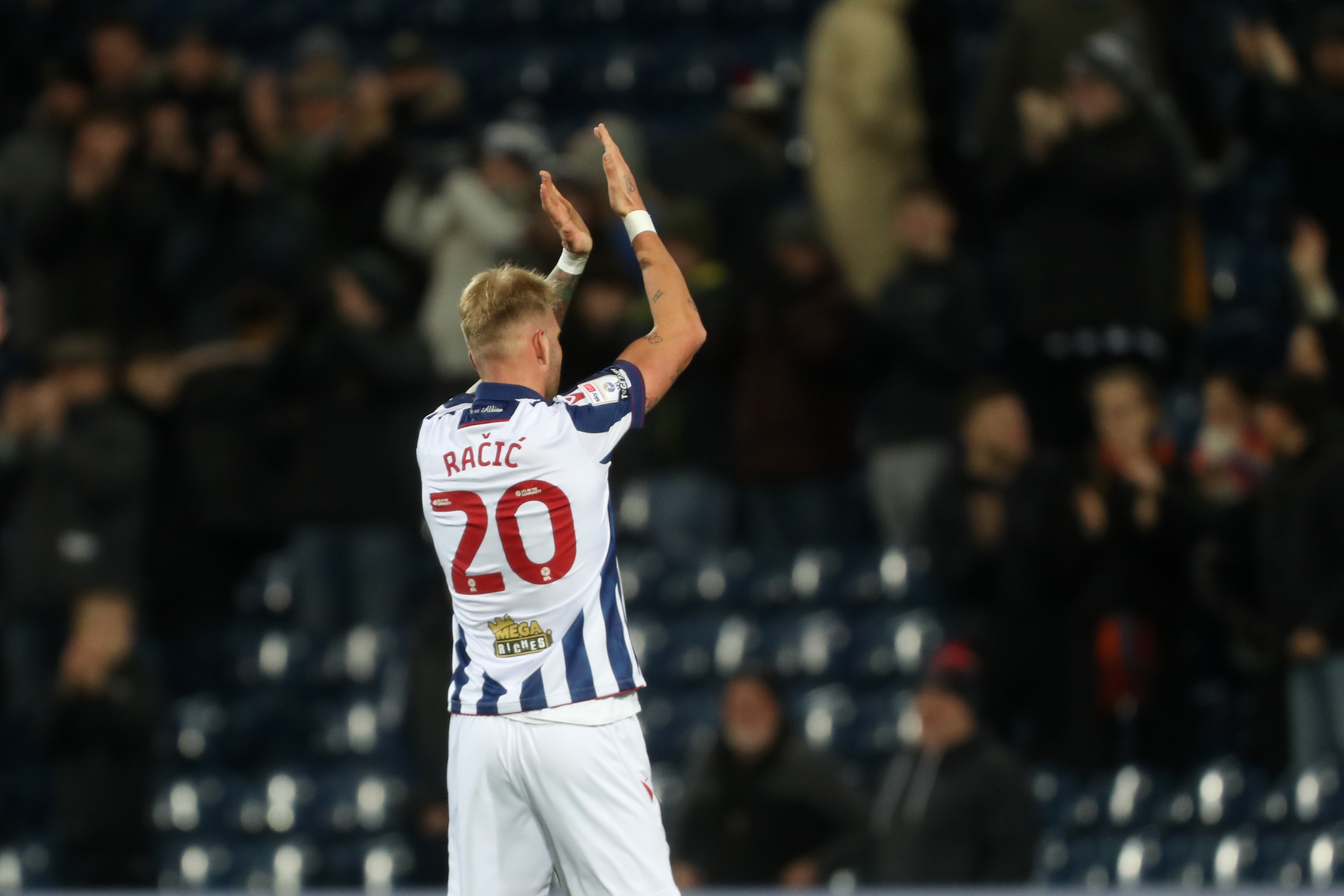 Uroš Račić applauds supporters after Albion's win against Coventry City 