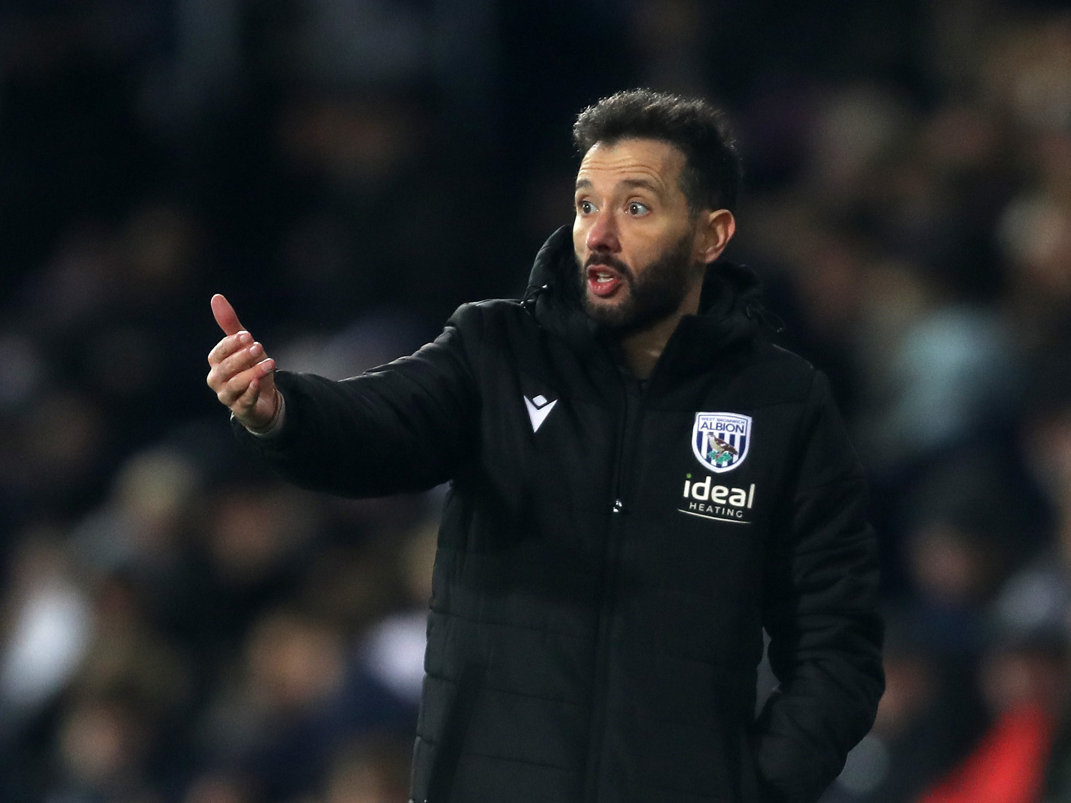 Carlos Corberán delivering instructions to players on the side of the pitch against Coventry City 