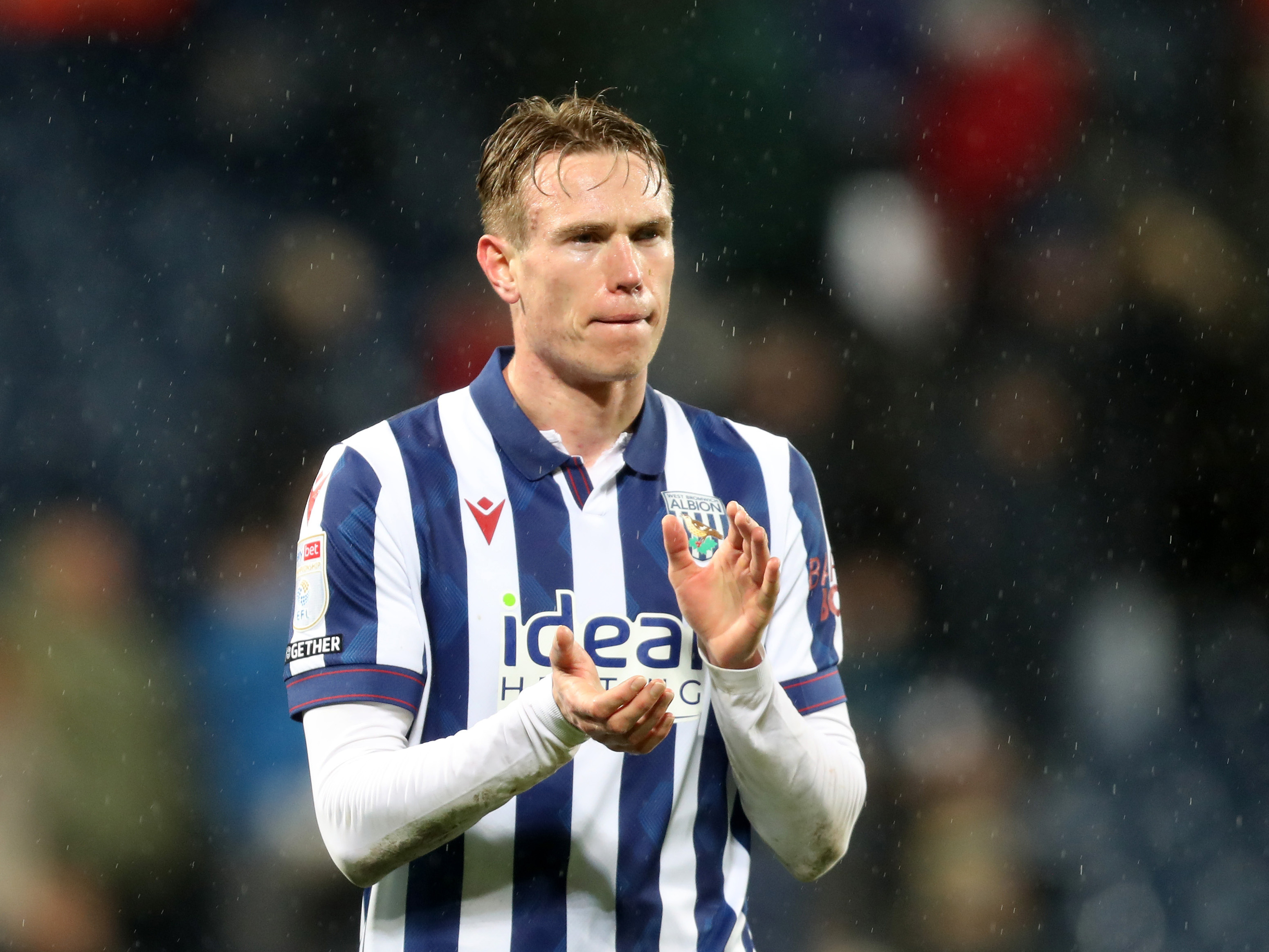 Torbjørn Heggem applauding Albion fans while wearing the home kit 