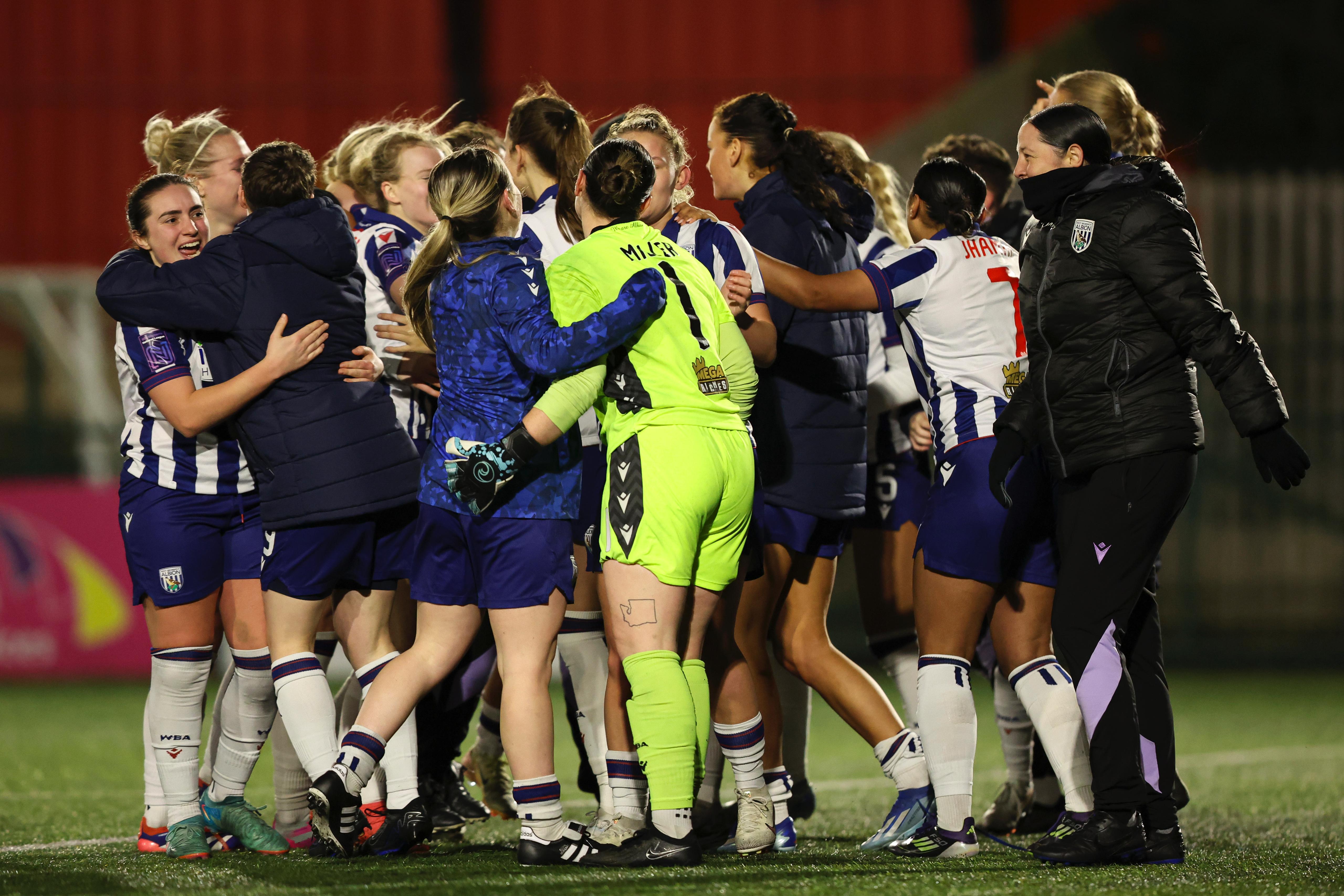 Albion Women players and staff celebrate after beating Wolves on pens 