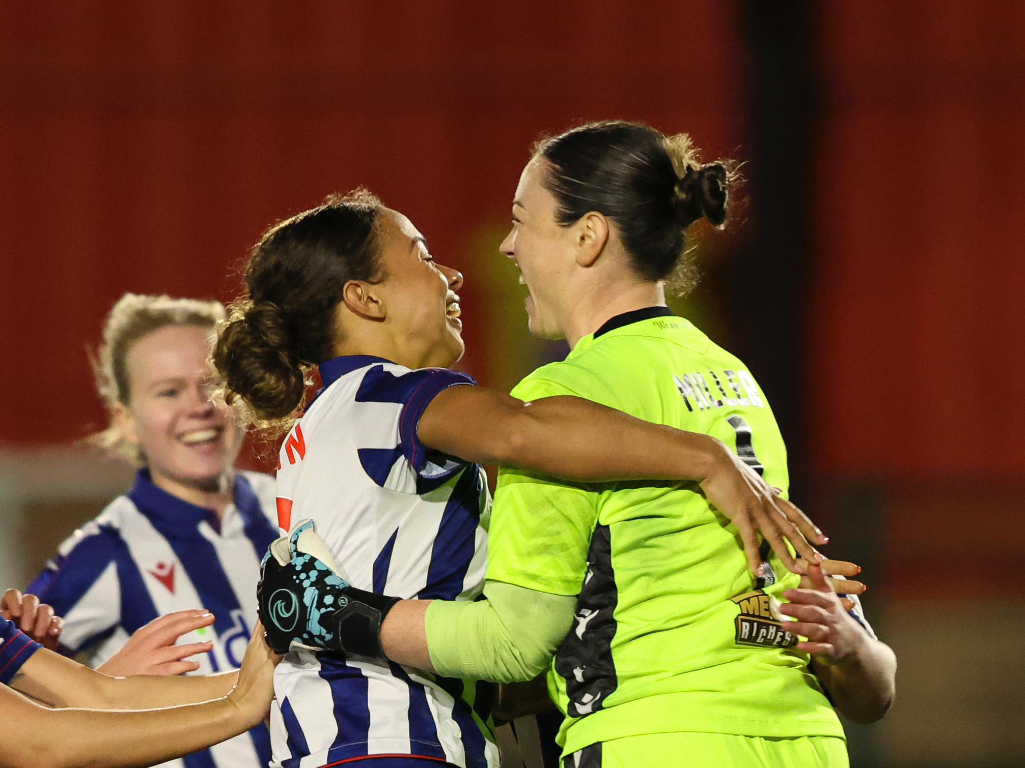 Anna Miller celebrates with Ash Brown after beating Wolves 