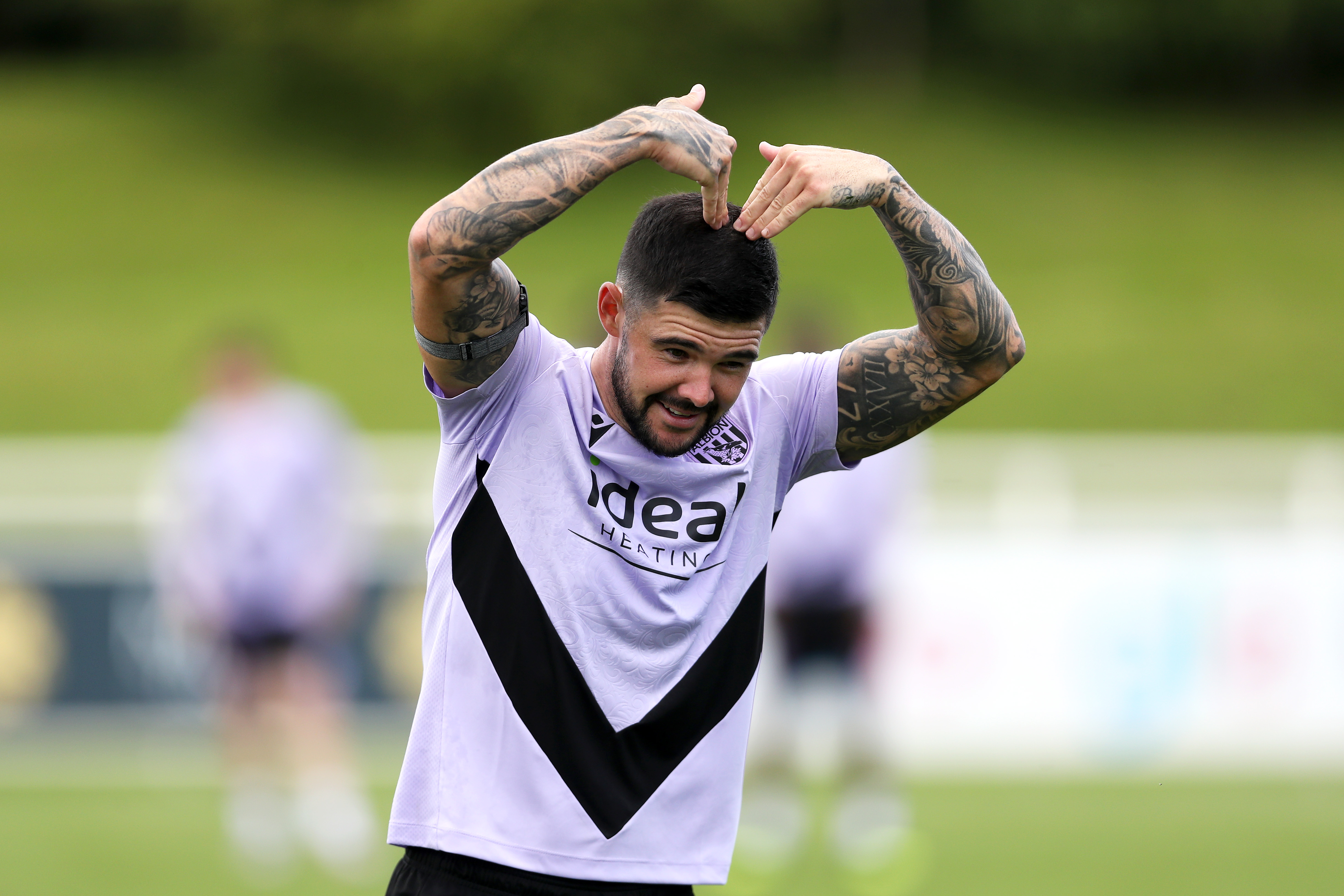 Alex Mowatt with his hands on his head during a training session 